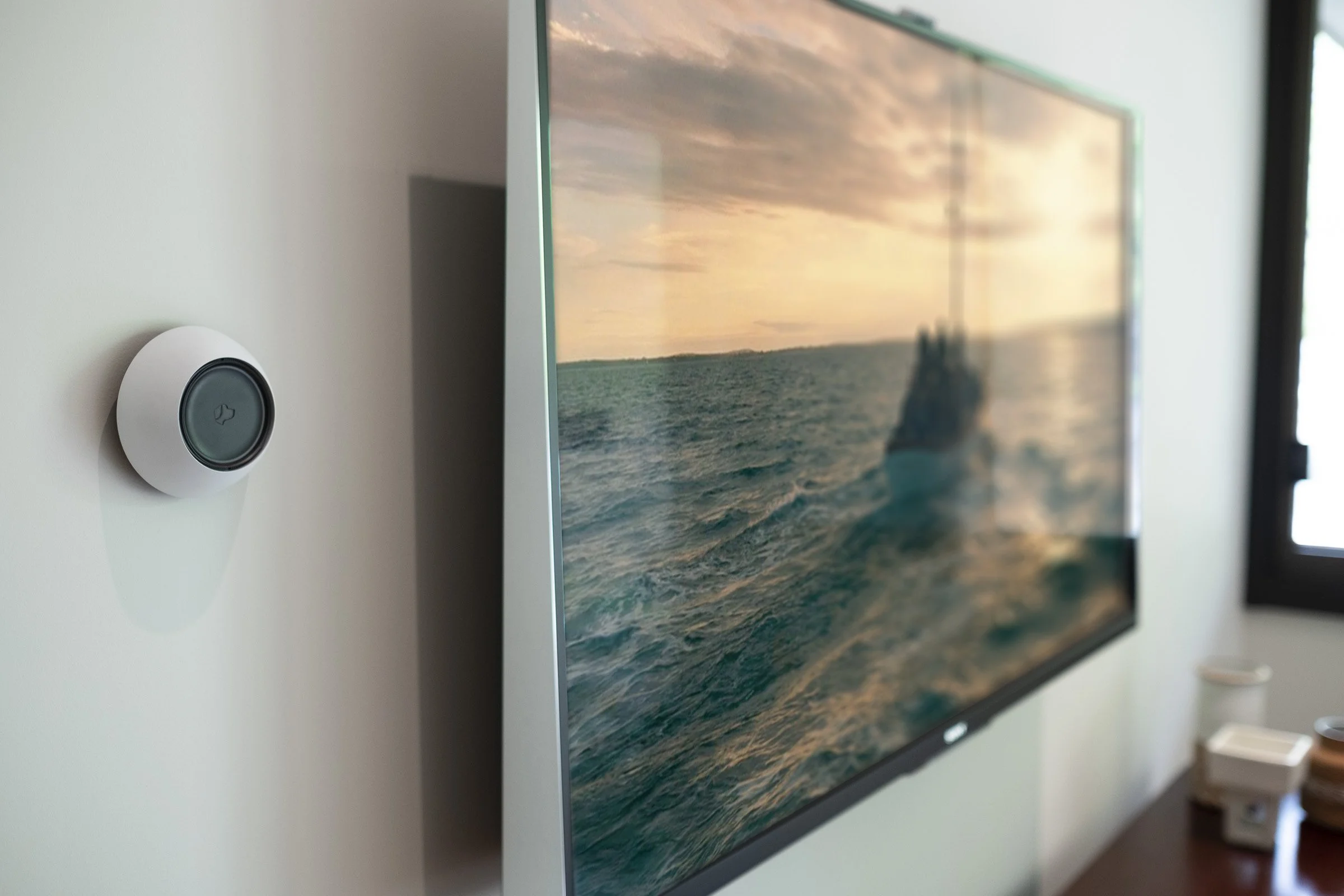 Television and Josh.ai wall device in a luxury media room | Josh.ai dealer Seattle and Bellevue