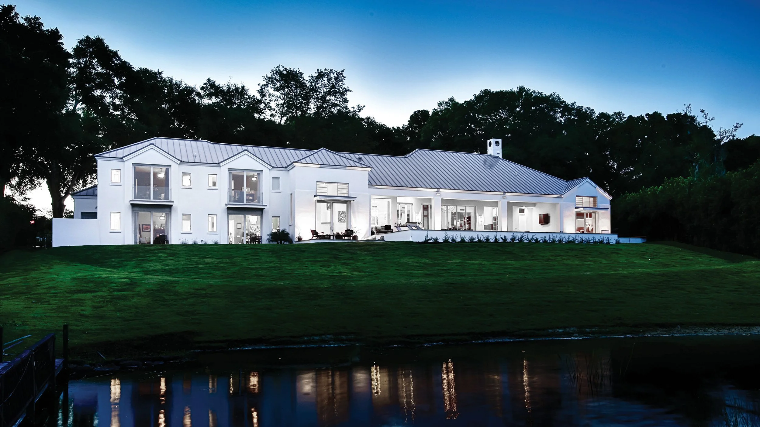 Luxury Pacific Northwest waterfront residence with integrated smart home lighting at dusk | VIP Smart Homes Seattle