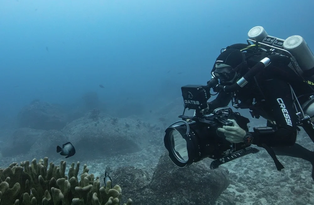 Cory on a closed-circuit rebreather filming reef fish with a RED camera in a Gates housing