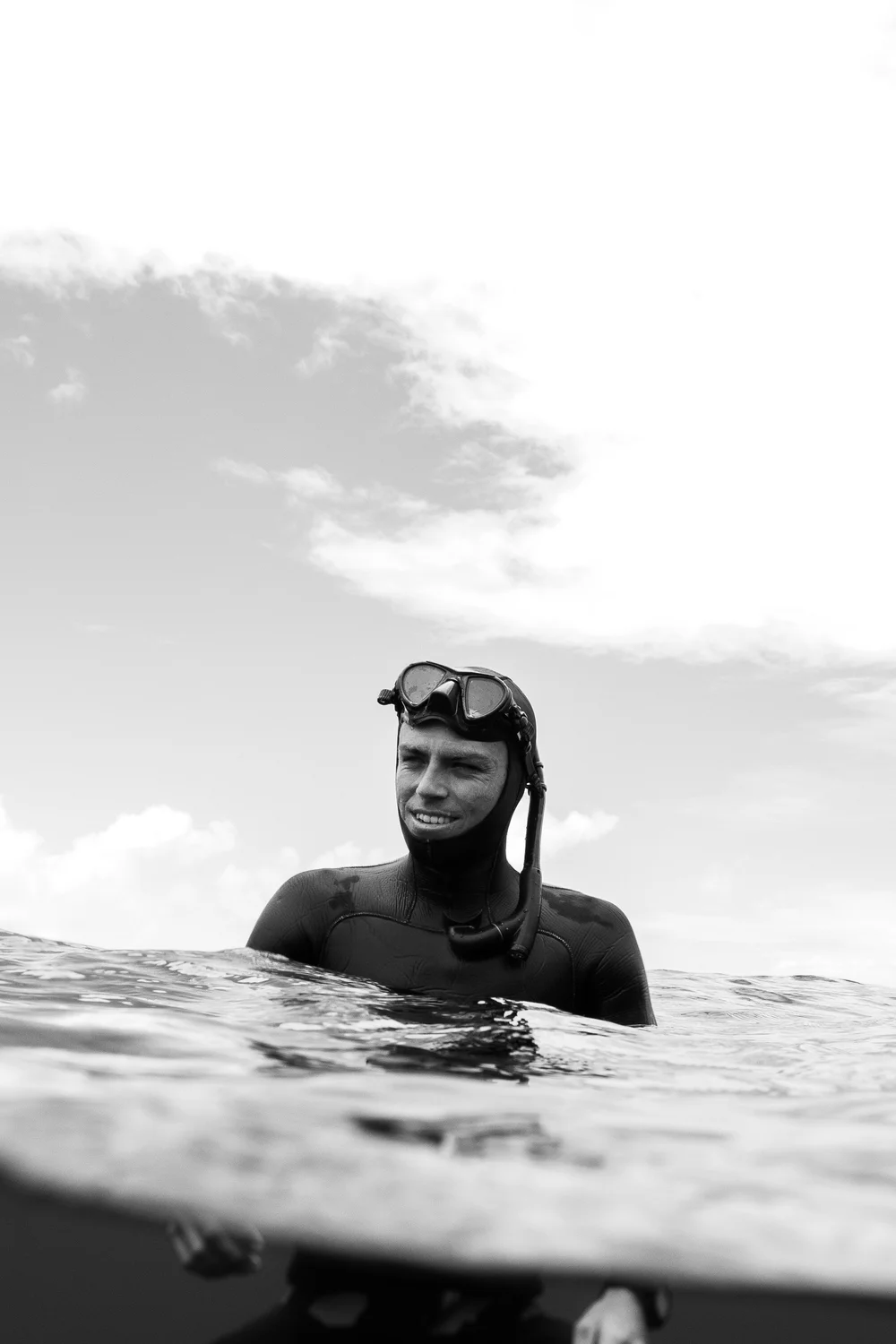 Portrait of Cory at the surface in a freediving wetsuit and mask
