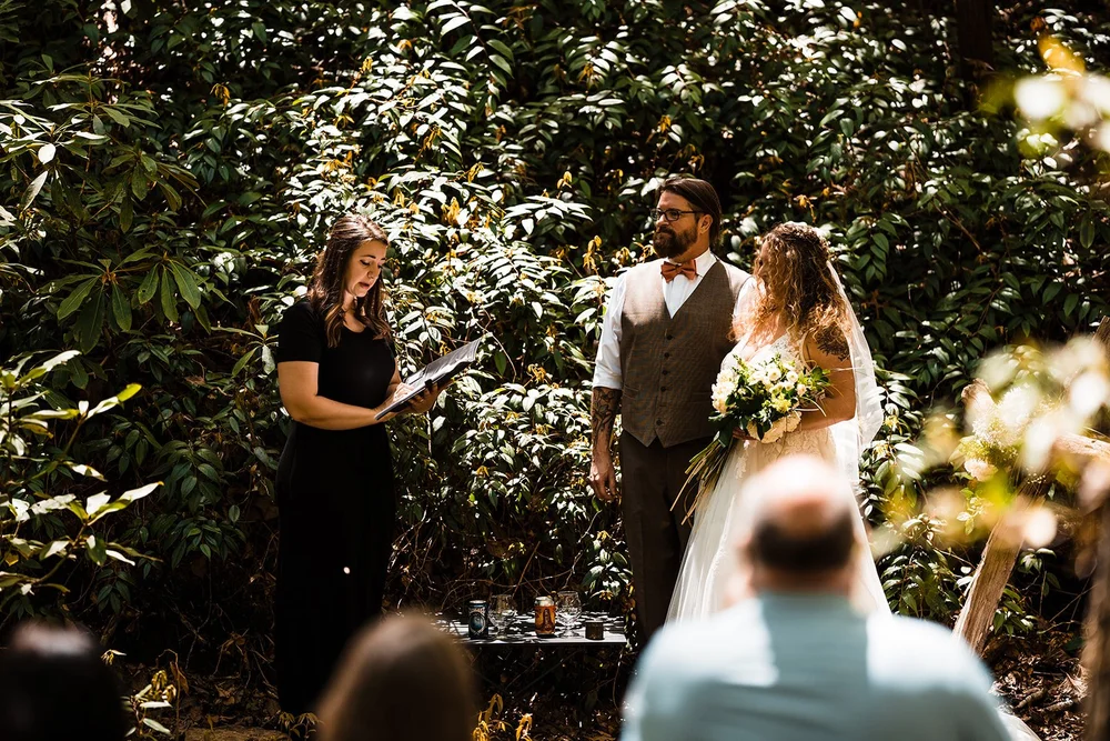 Kimb and Roland during their intimate forest wedding ceremony with family near Brevard