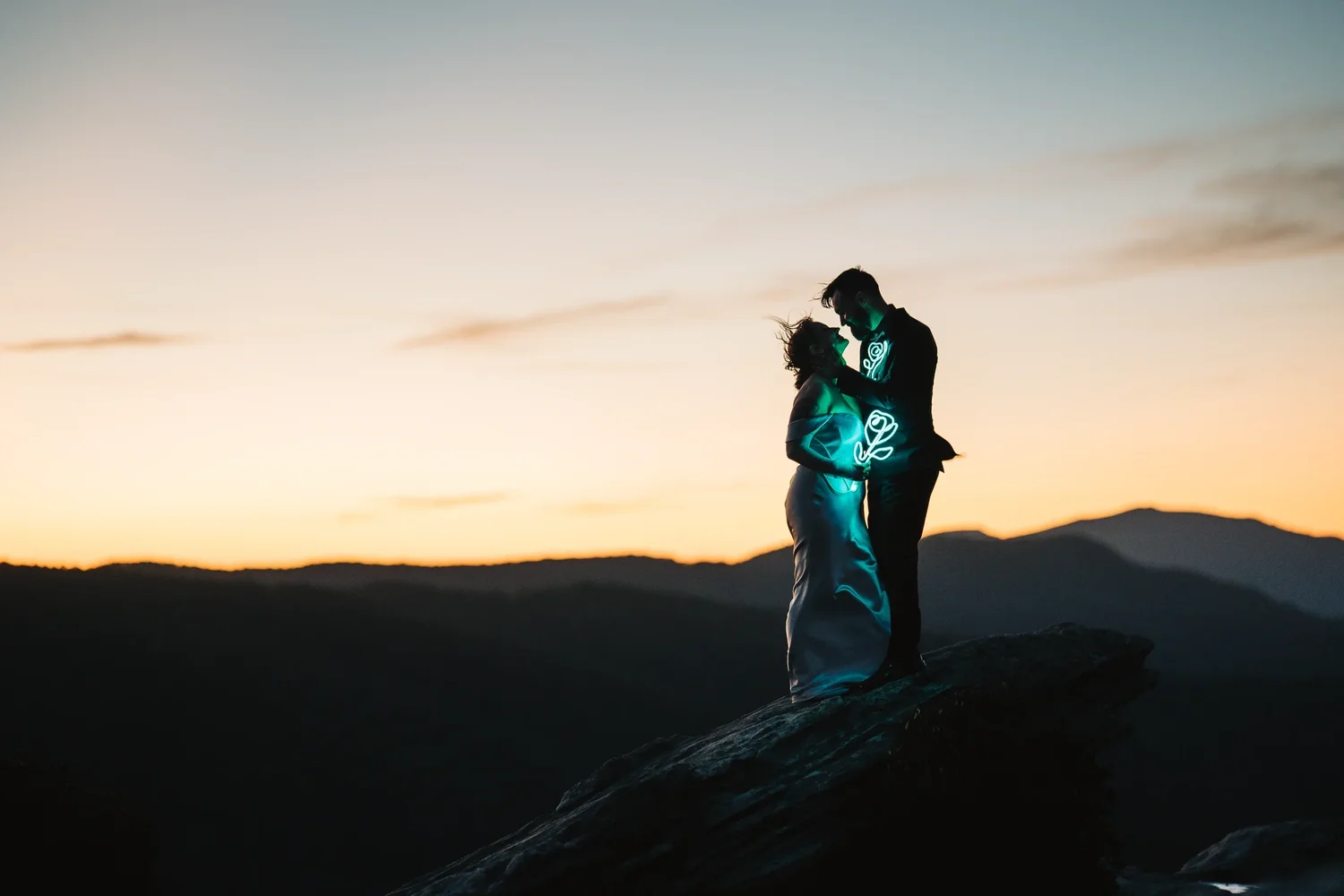 Bryanna and RJ with handmade neon rose details during blue hour in the North Carolina mountains