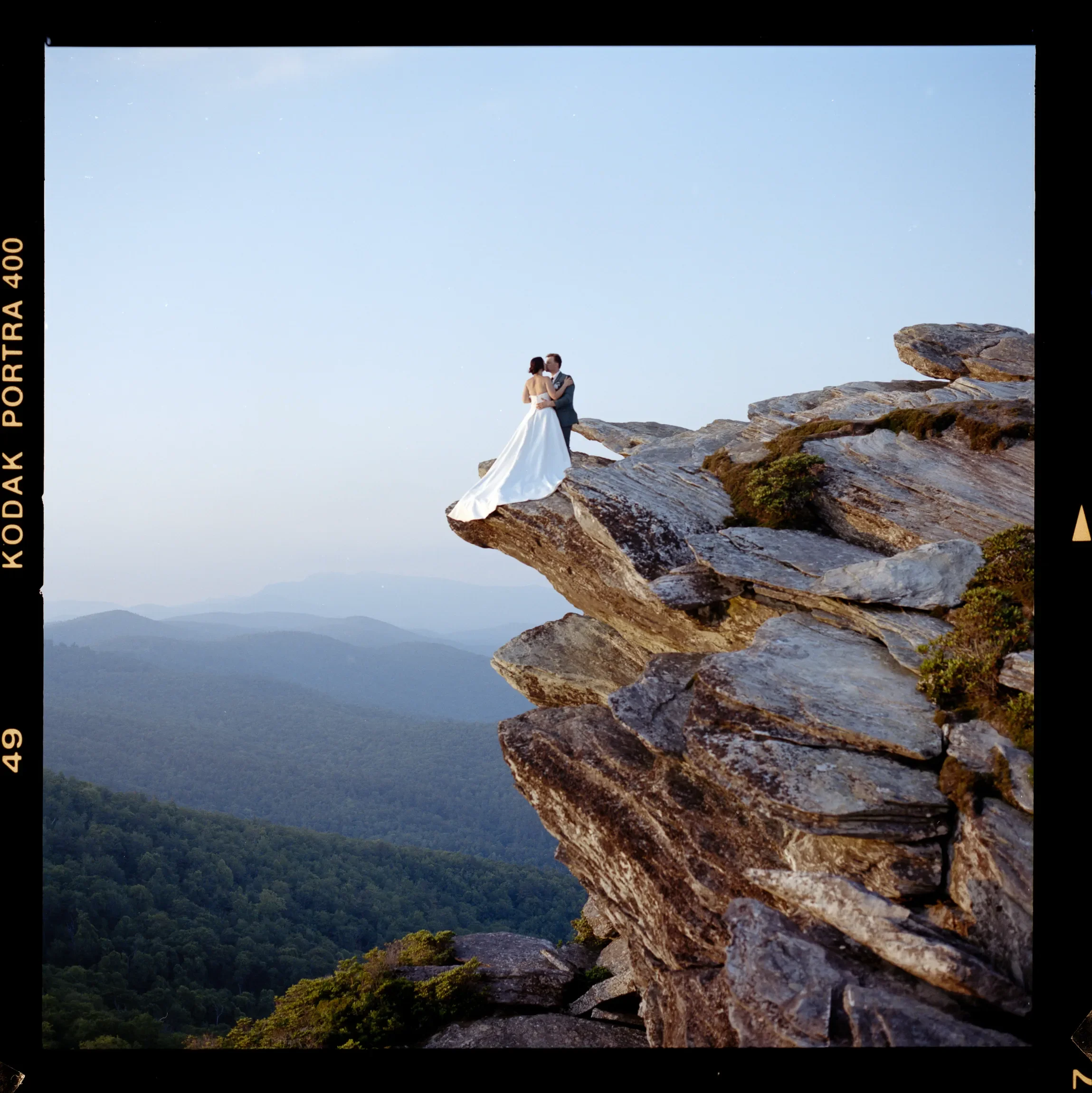 Couple standing together on a mountain overlook during an adventure elopement in Western North Carolina