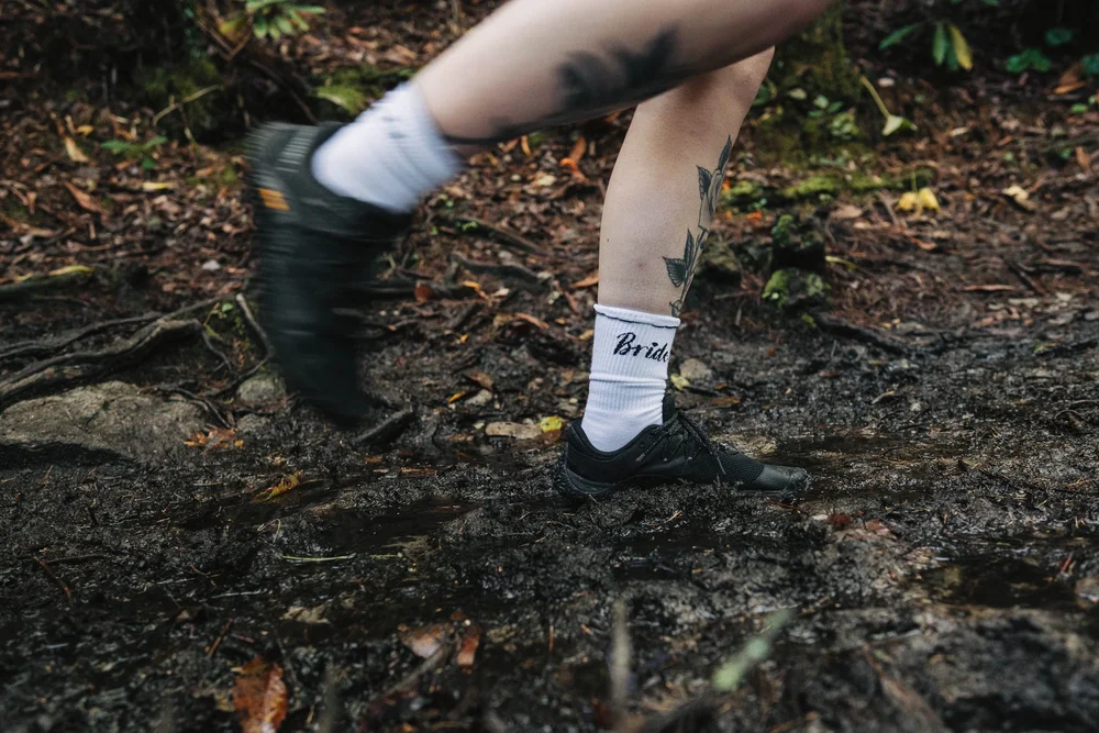 Bryanna and RJ making their way through muddy trail conditions during their mountain adventure