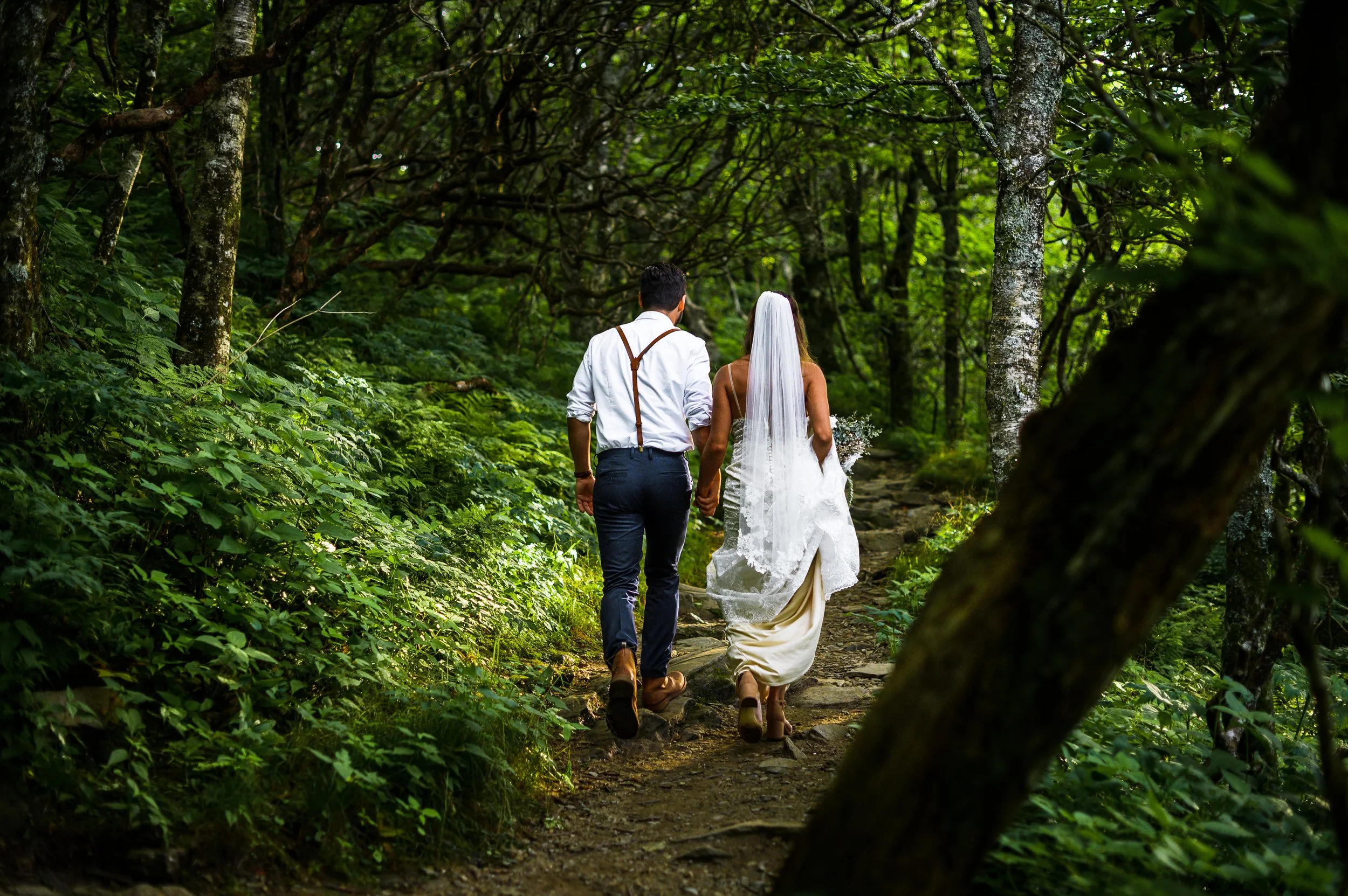 Couple hiking to Craggy Gardens for an elopement with Blue Ridge Parkway mountain views