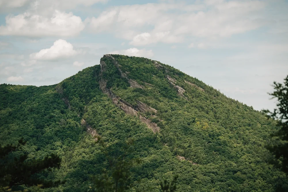 Mackenzie and Michael beginning the next part of their wedding day before sunset portraits on Hawksbill Mountain.