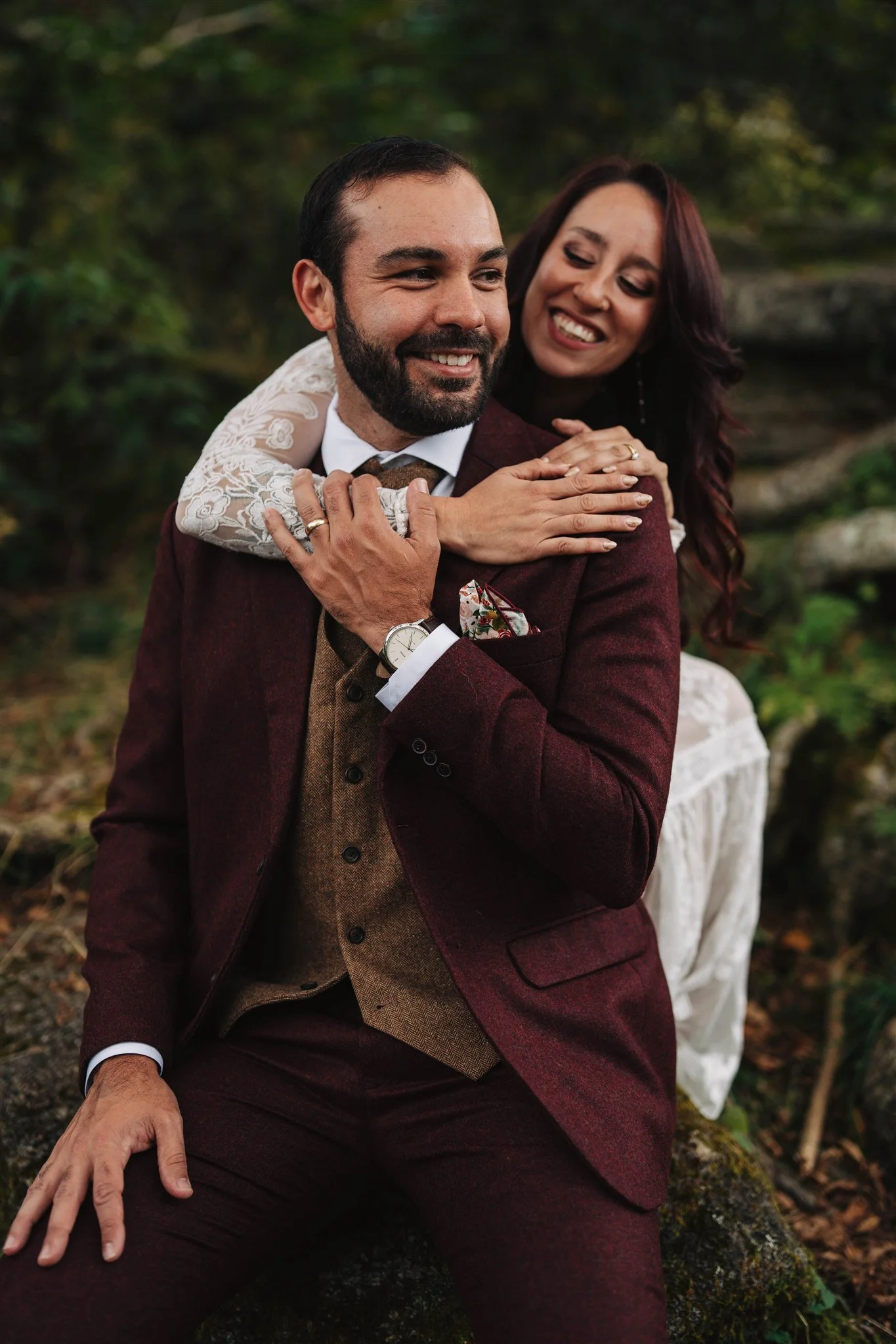 Couple standing together on a mountain overlook in colorful elopement outfits in Western North Carolina