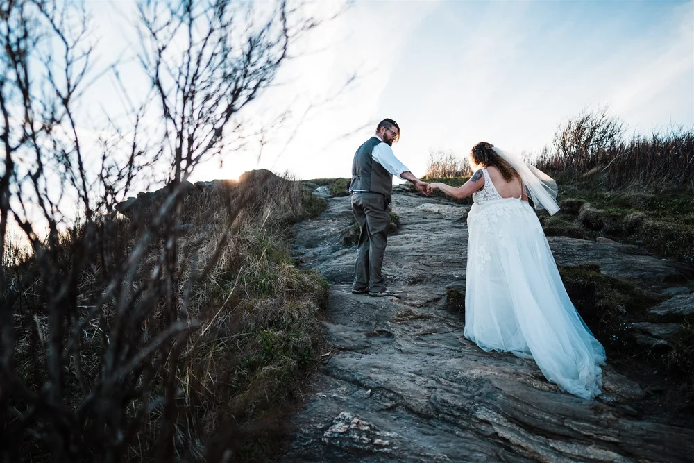 Kimb and Roland exploring the mountains together during their sunset wedding portrait session