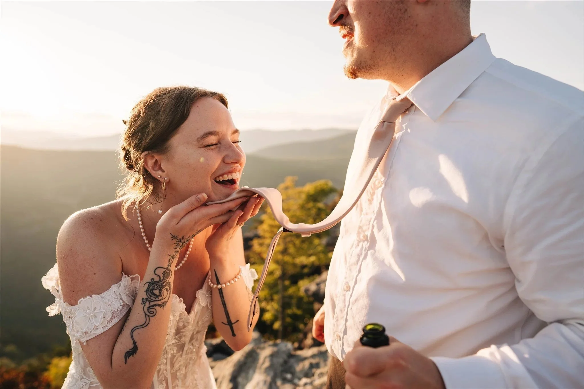 A couple laughing together during a mountain elopement in Western North Carolina