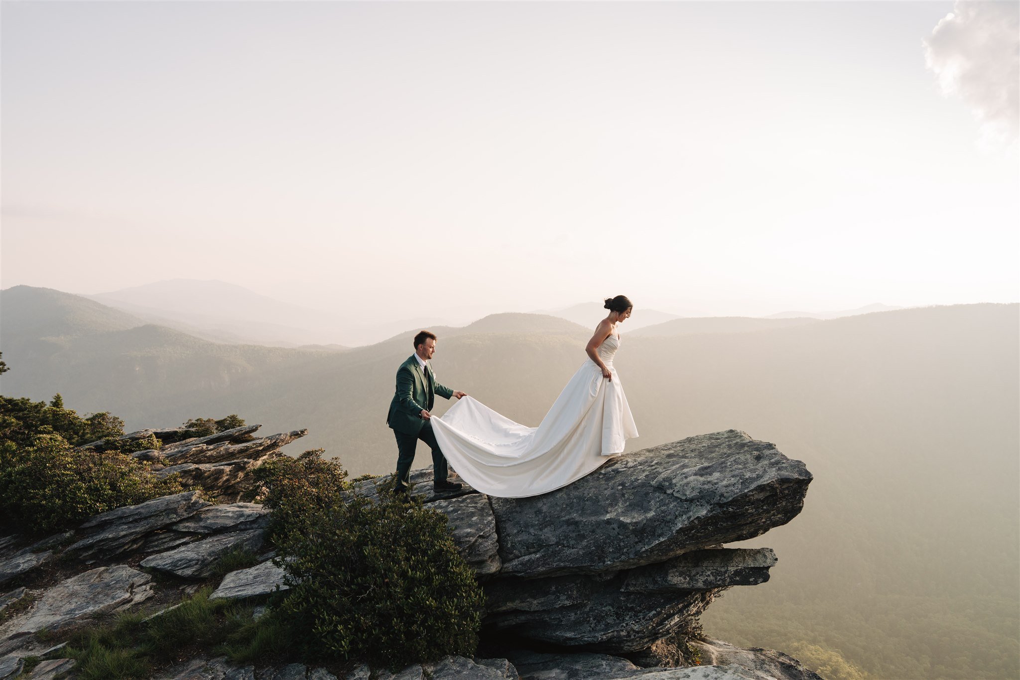 Bride wearing a full wedding dress outdoors in the mountains during an Asheville elopement