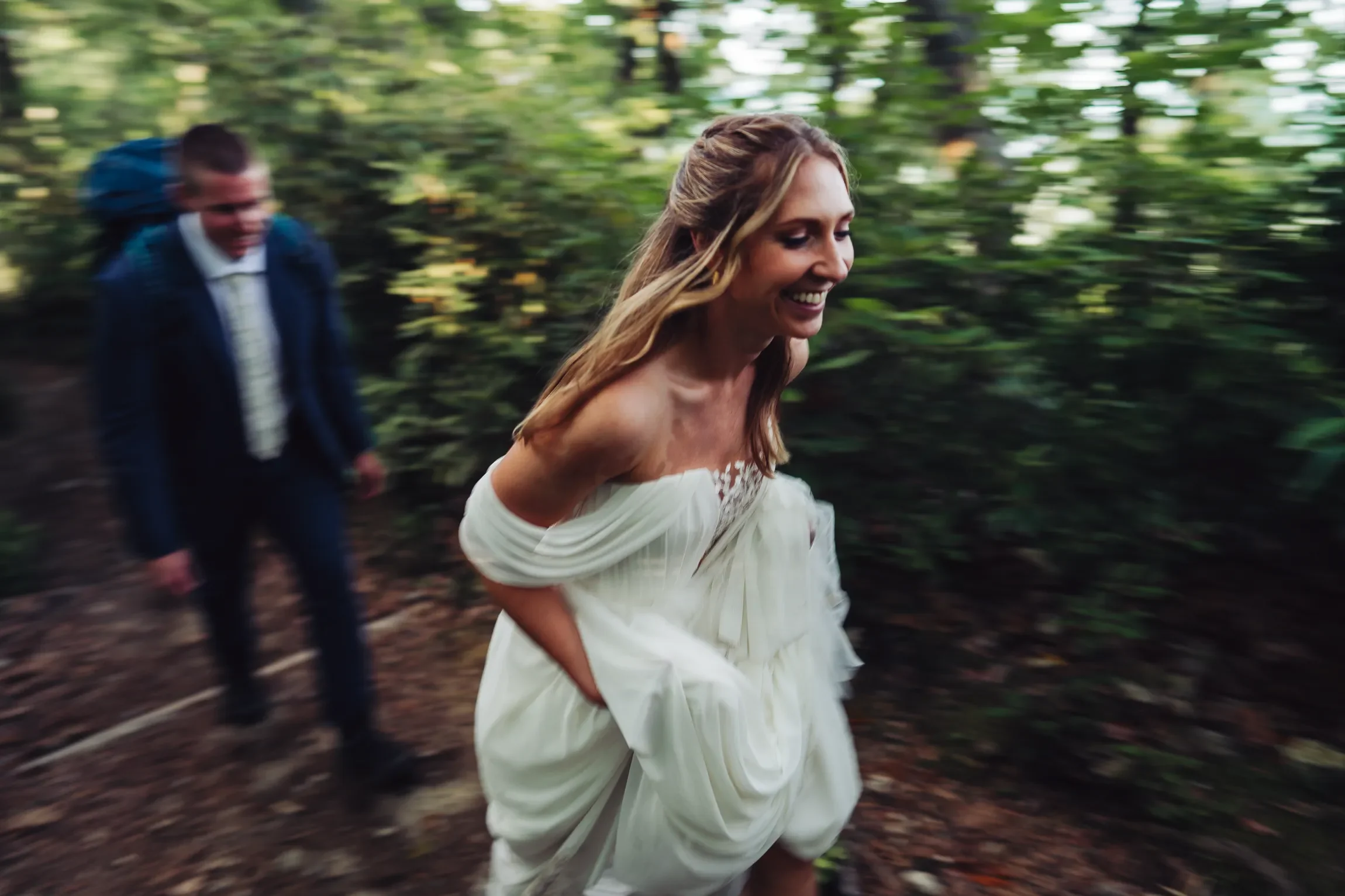 Bride moving through a mountain landscape in wedding attire during an outdoor elopement