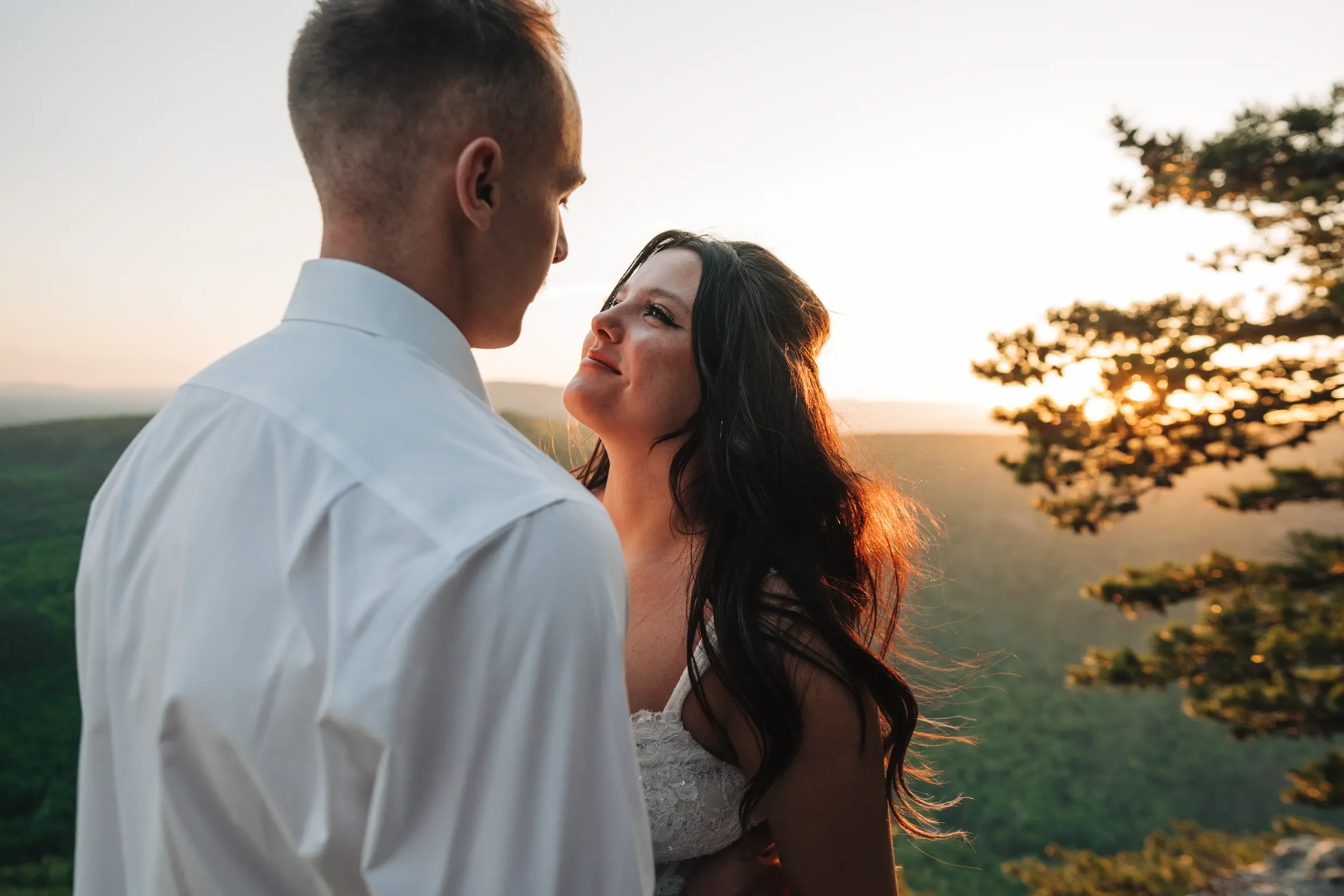 Bella standing on a mountain overlook during her wedding day