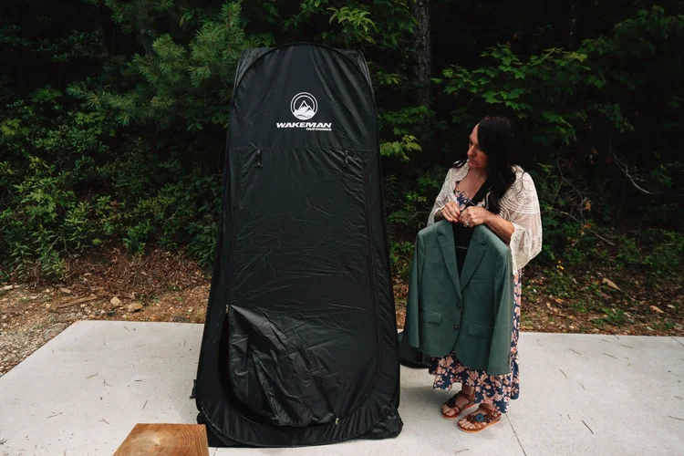 Michael getting ready in a pop-up tent before his Wiseman's View wedding.