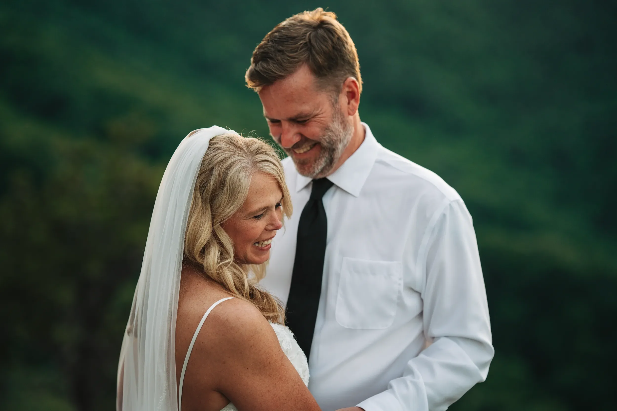 Dawn walking outdoors in her wedding dress after rain in the North Carolina mountains