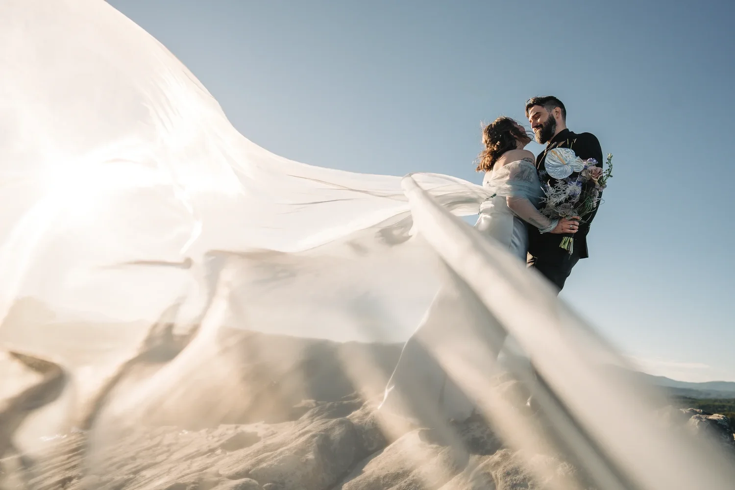 Bryanna and RJ with fresh flowers during their Hawksbill Mountain adventure session