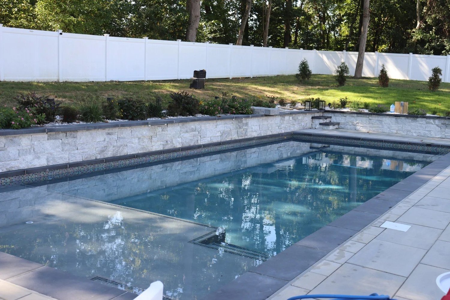 Tanning ledge and coordinated finishes in a Davidsonville custom pool
