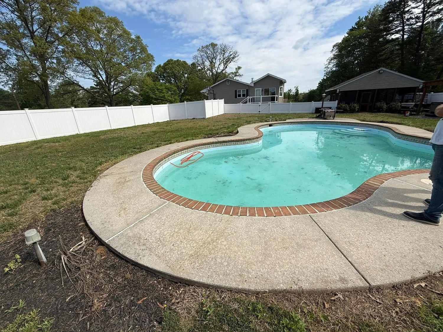 Original Gambrills pool with pale interior, brick coping and concrete surround before Oasis renovation