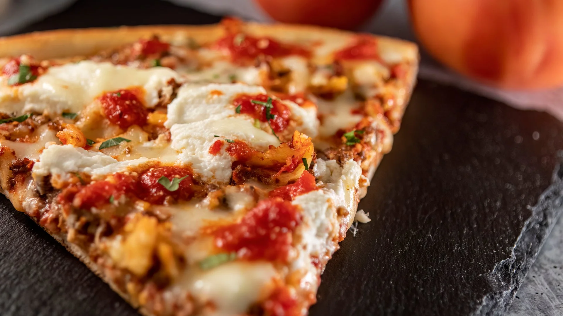 Pizza One specialty pizza with fresh cheese and tomato