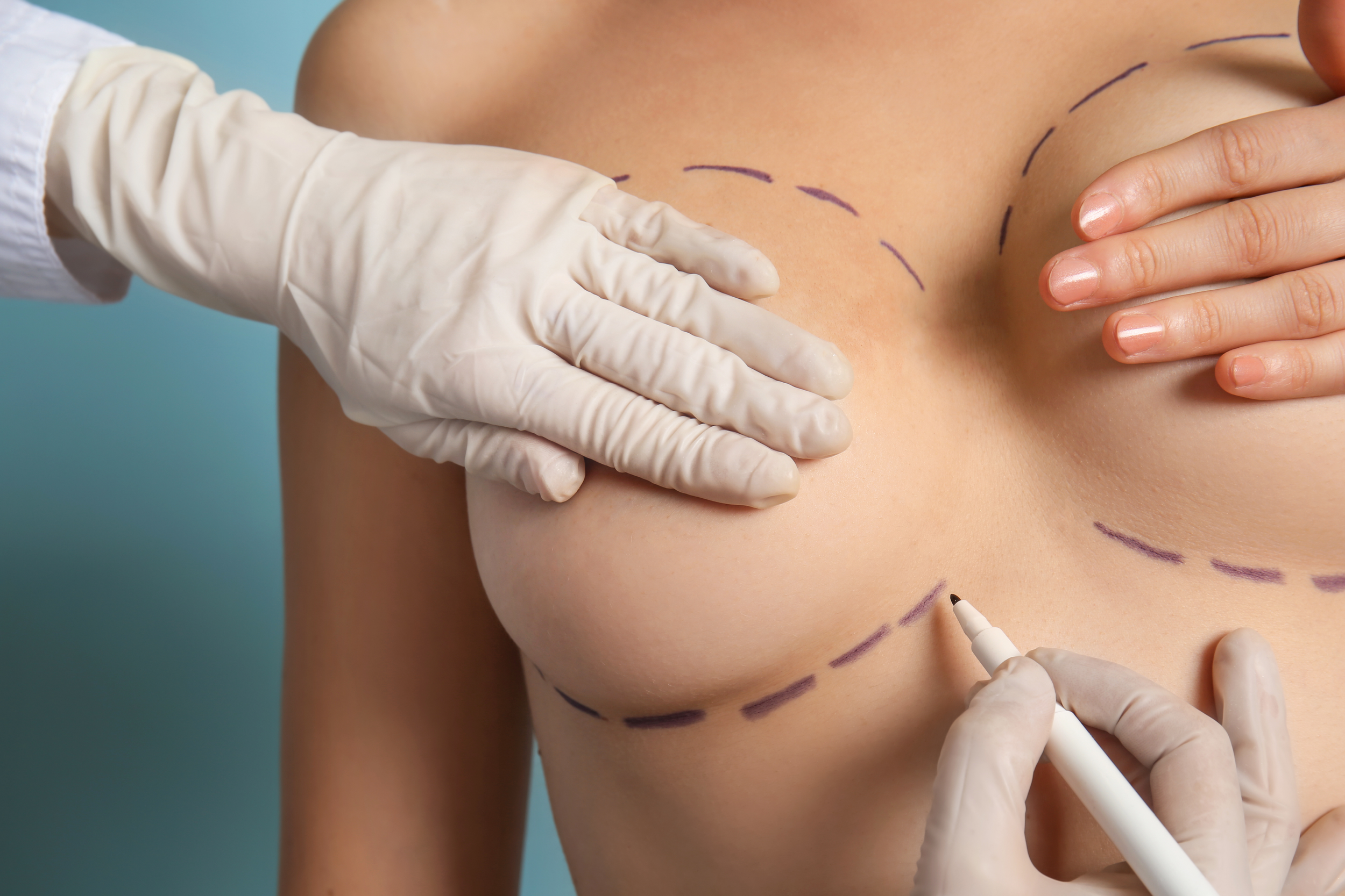 A plastic surgeon examines a patient's nose in a modern clinic setting