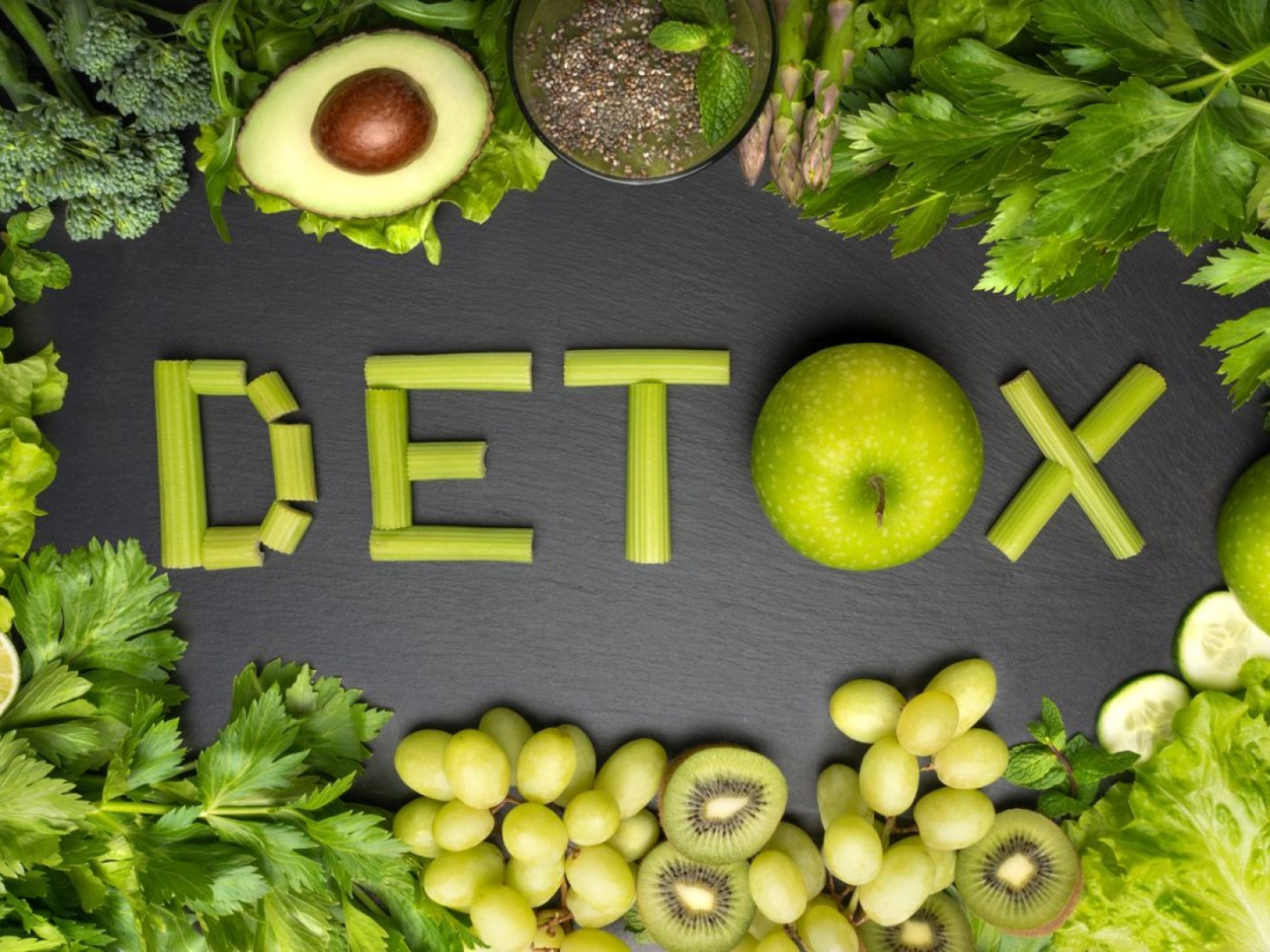 Word detox spelled with fresh vegetables and fruits representing natural detoxification and nutrition supporting metabolic health