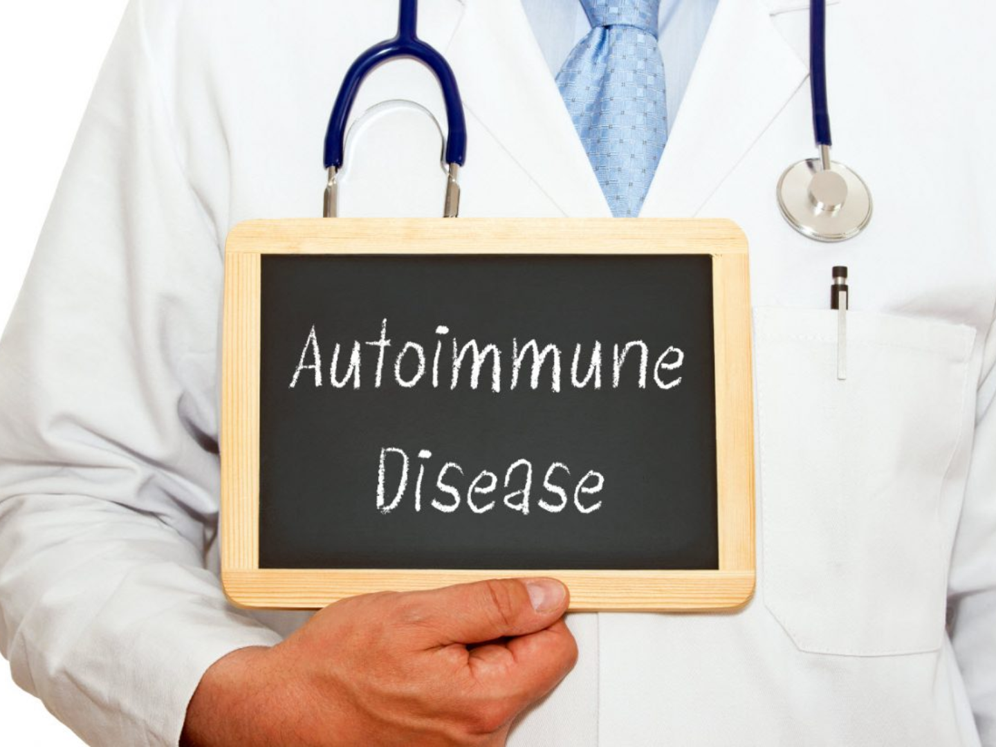 Doctor holding a chalkboard labeled autoimmune disease representing medical evaluation and integrative care for autoimmune disorders