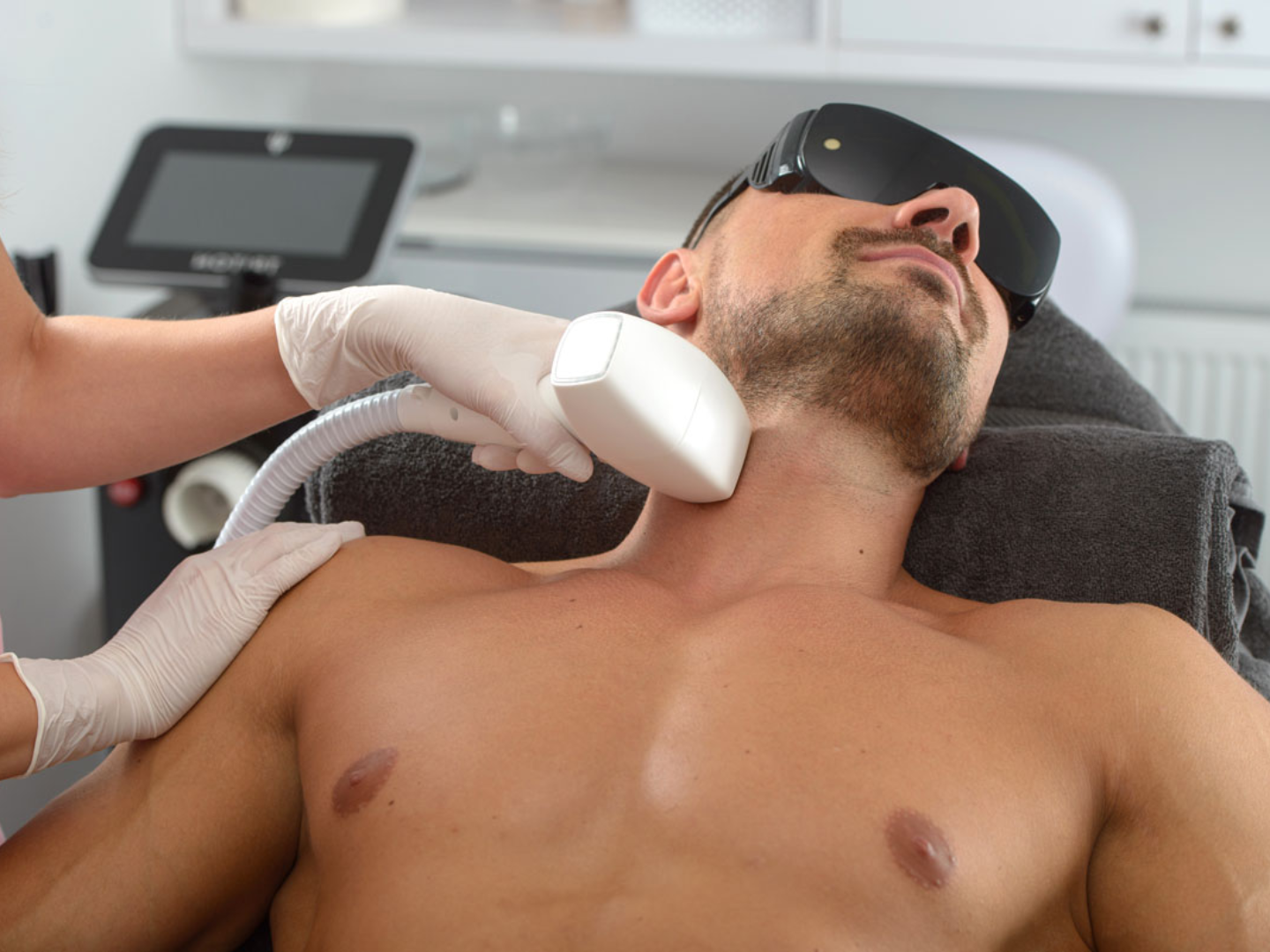 Man receiving laser hair removal treatment on the chest with Soprano Titanium at SageMED