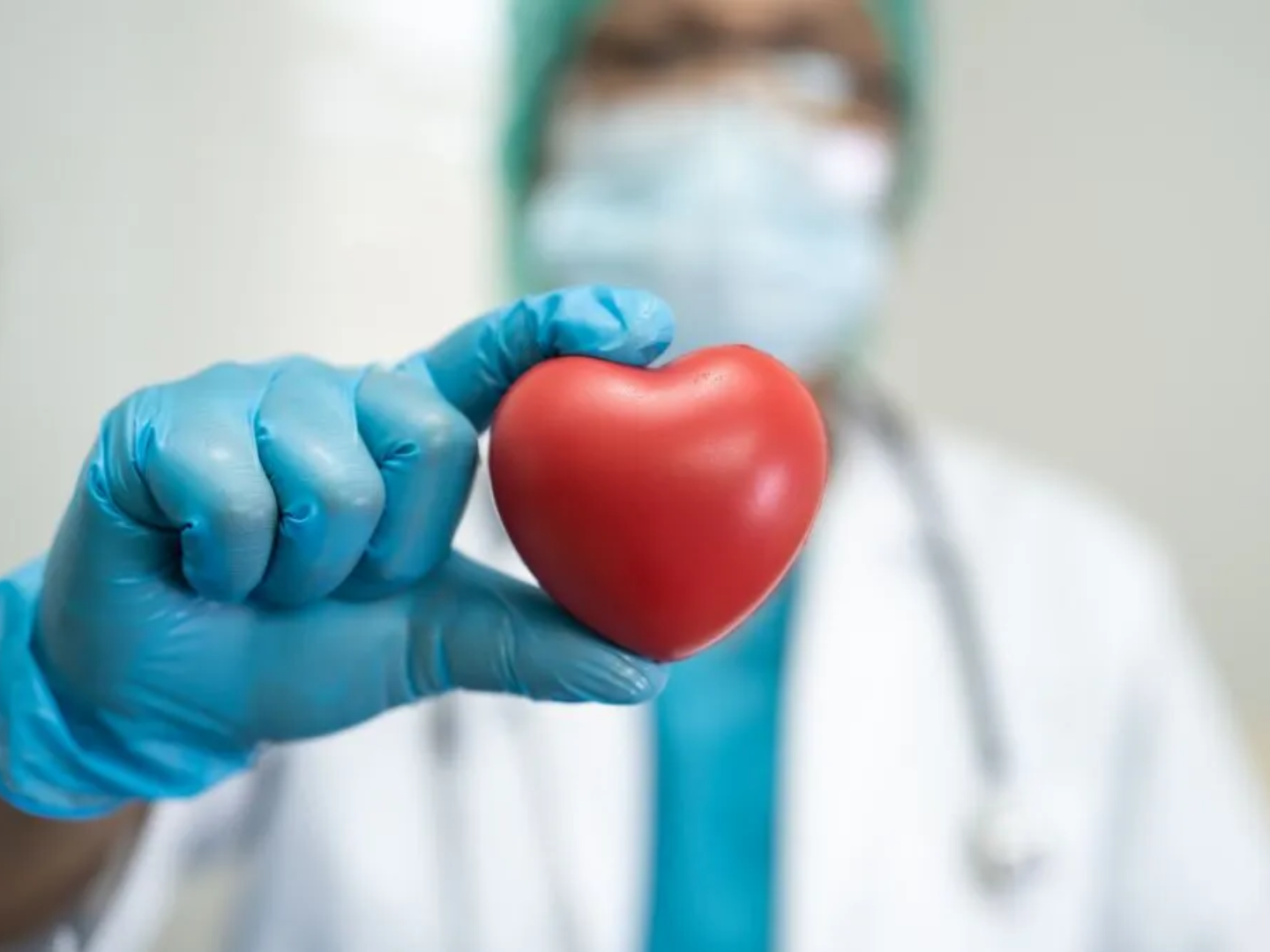 Clinician holding a heart symbol representing cardiometabolic health, heart risk prevention, and metabolic wellness support