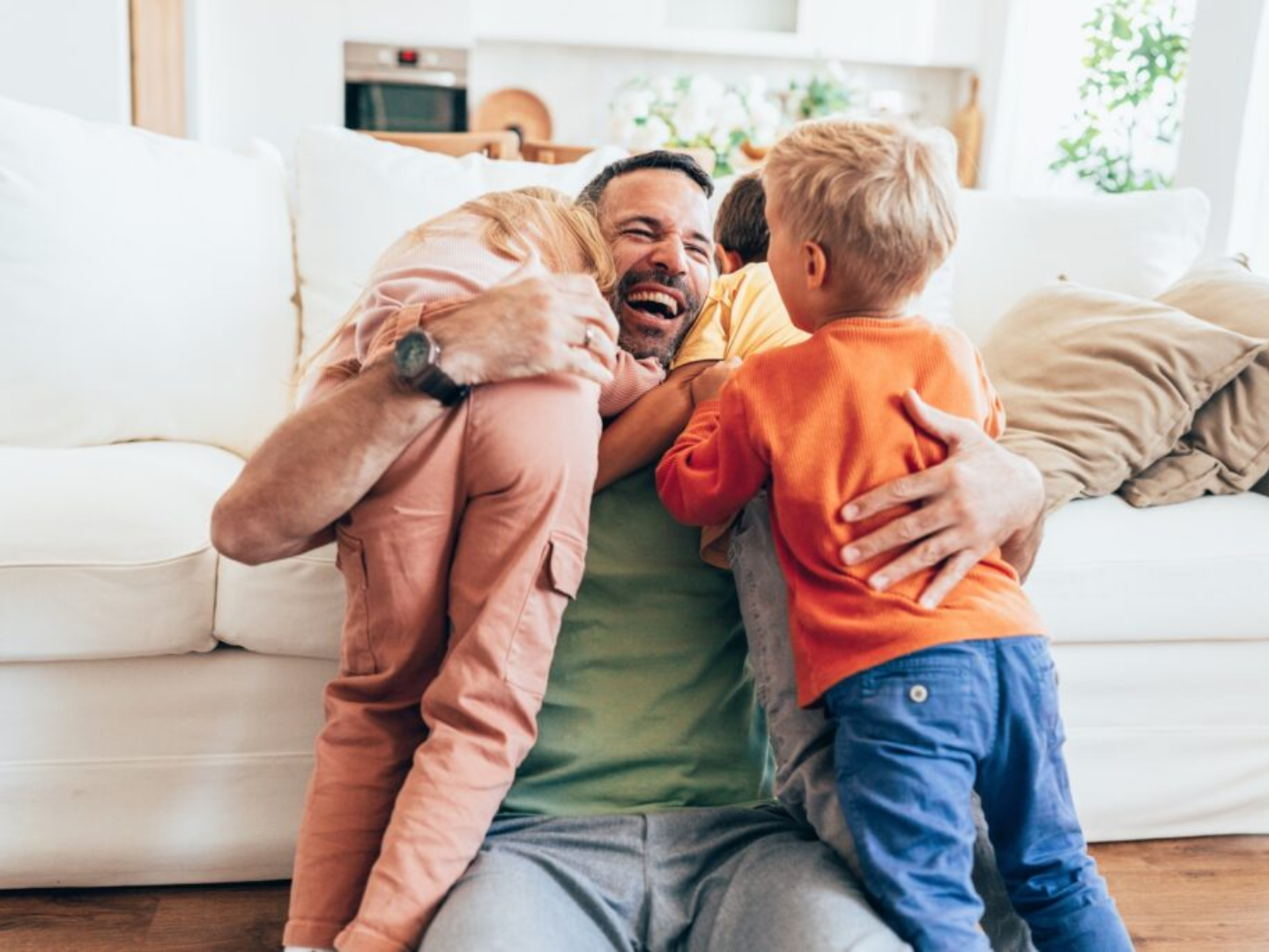 Father hugging and playing with his child representing healthy family bonding and child development supported by pediatric care