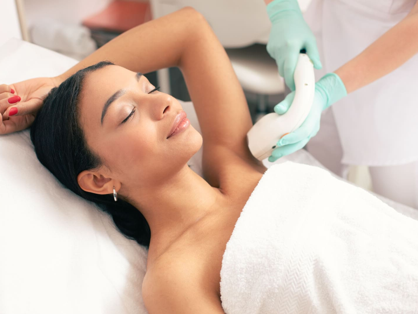 Woman receiving Soprano Titanium laser hair removal treatment at SageMED in Bellevue