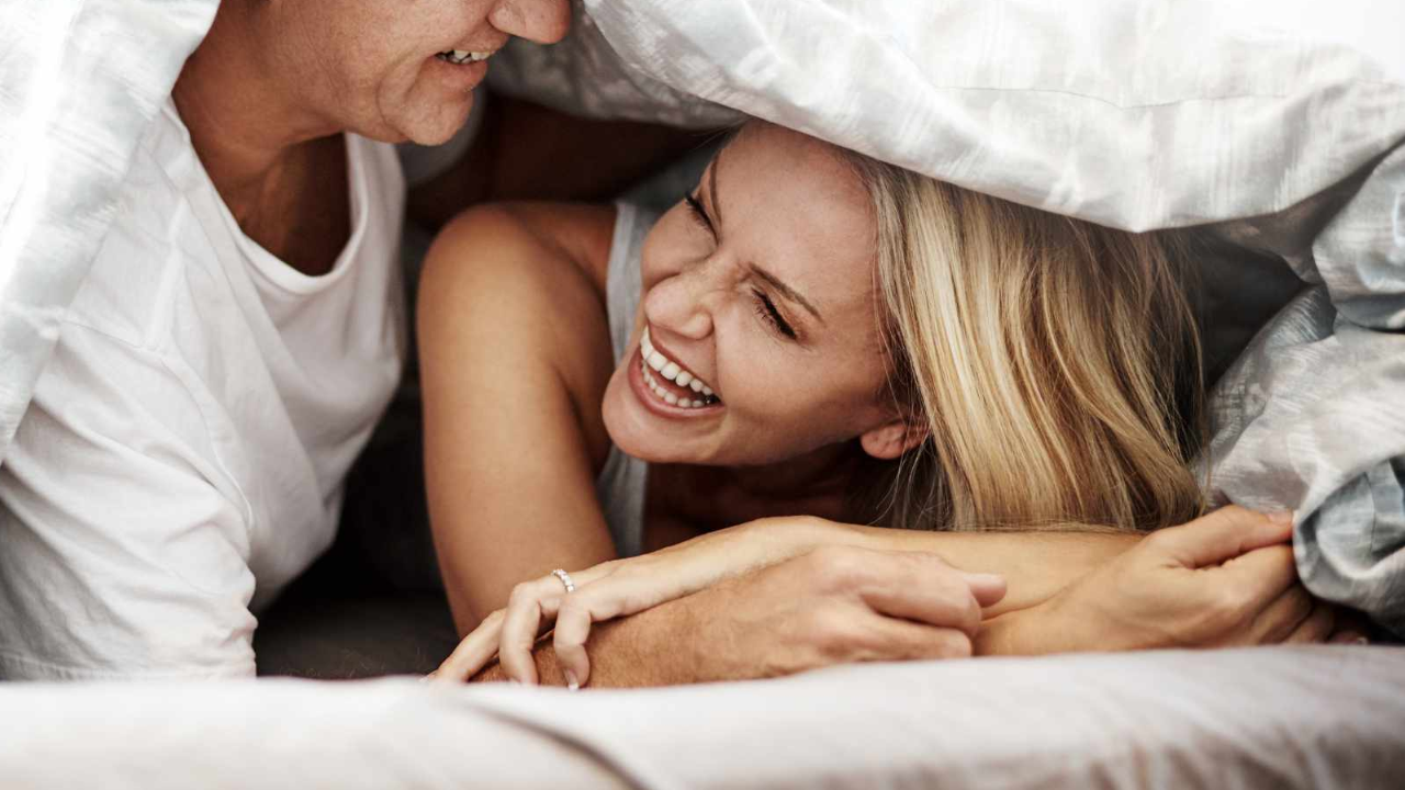 Couple smiling together, representing improved comfort and confidence with intimate wellness care