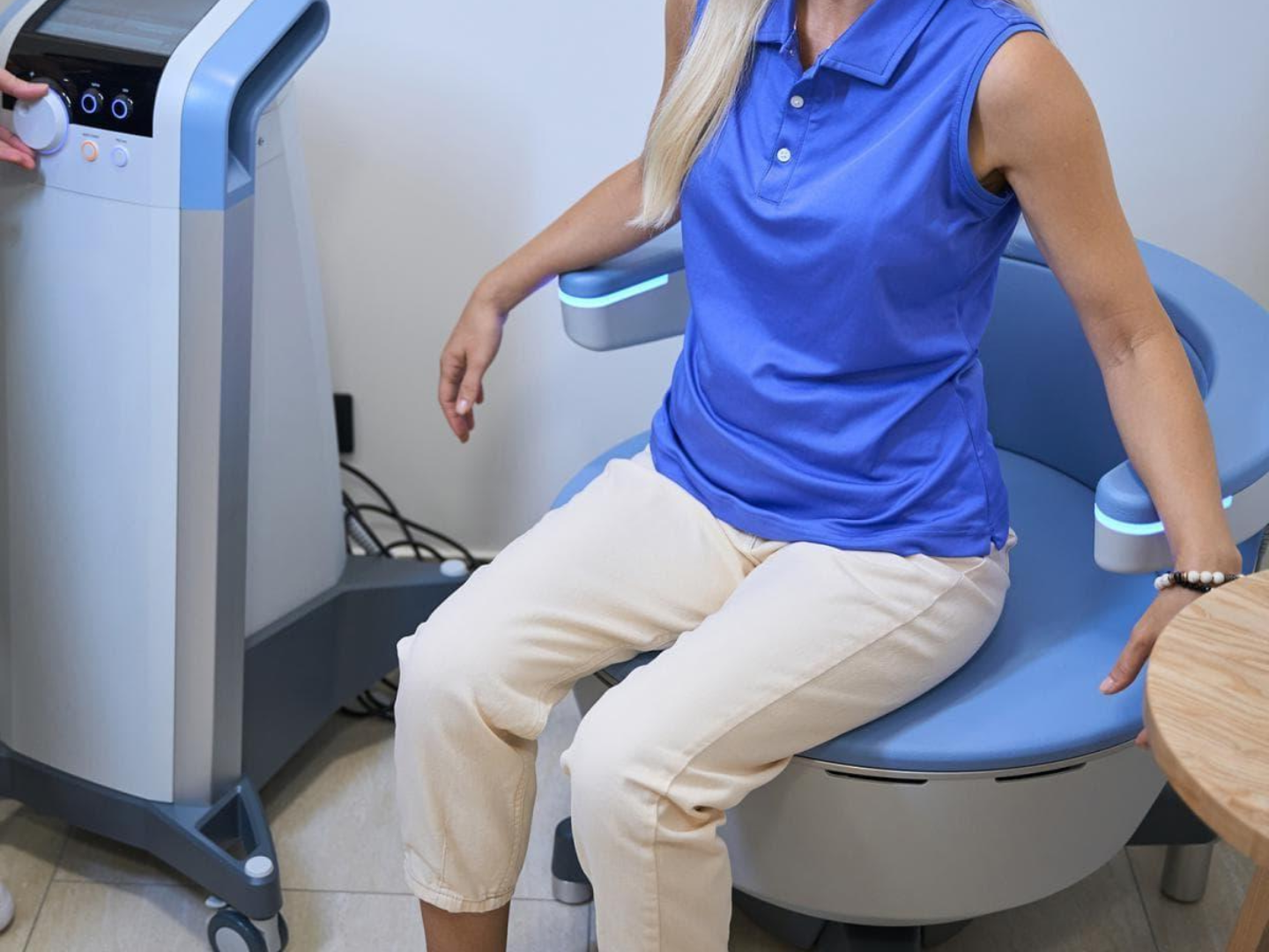Woman seated on the BTL Emsella chair during pelvic floor treatment at SageMED in Bellevue