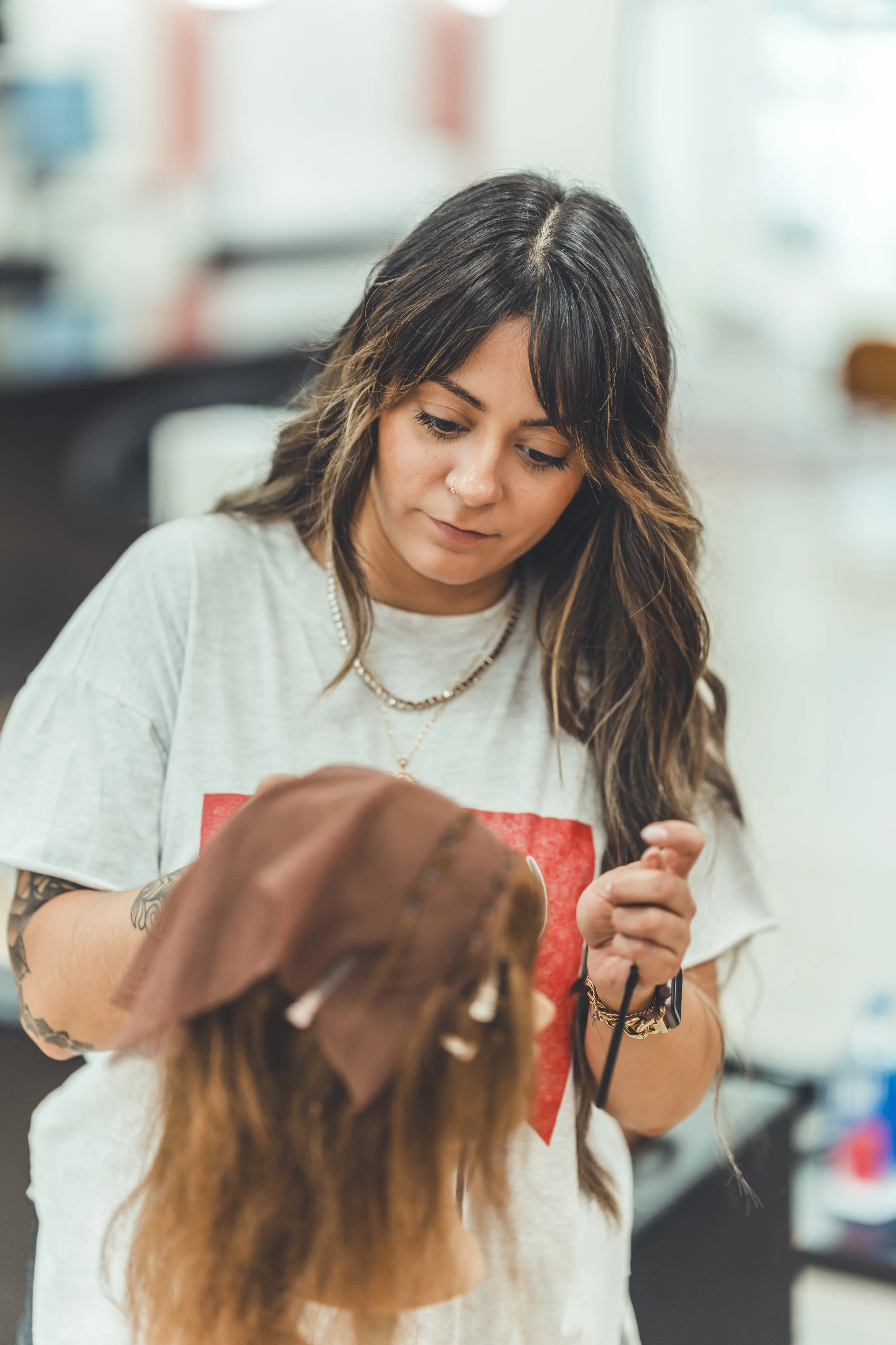 Stylist holding a finished hair unit