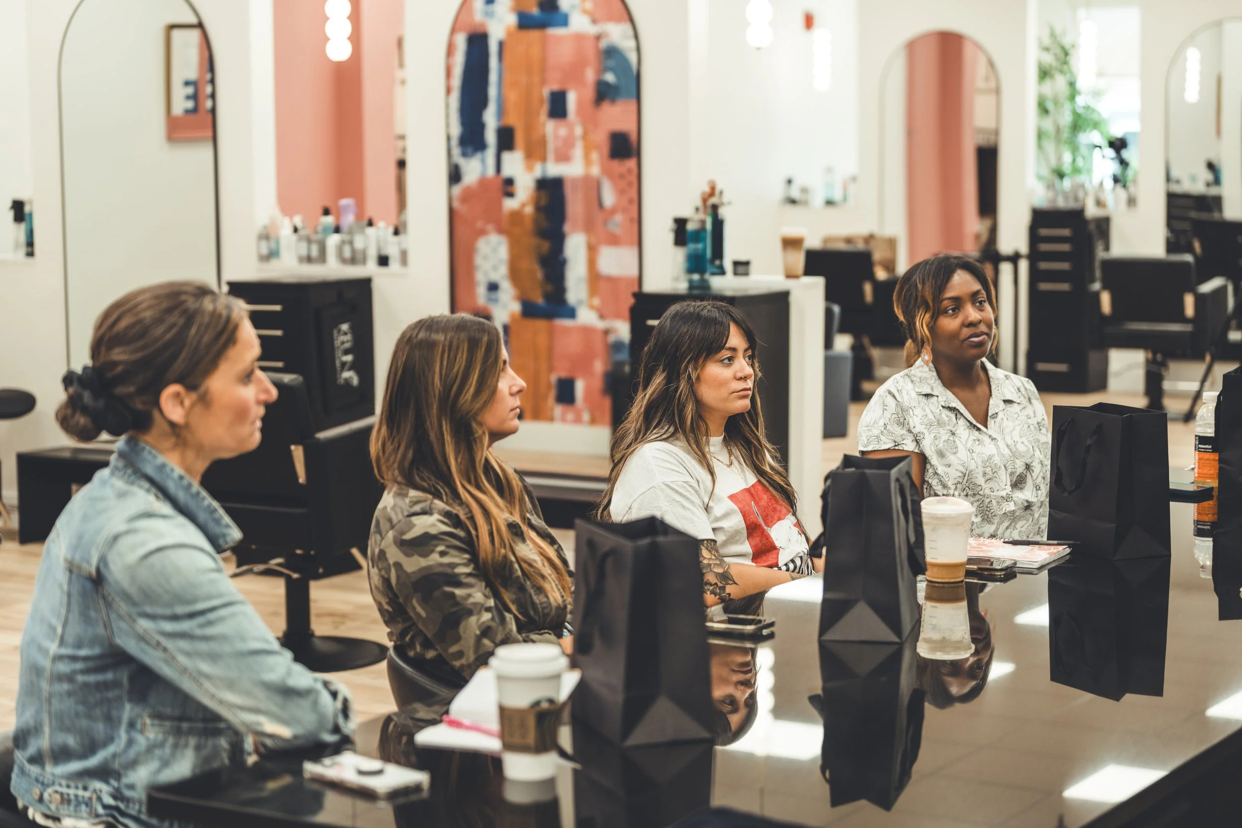 Hairstylists gathered in a salon training environment