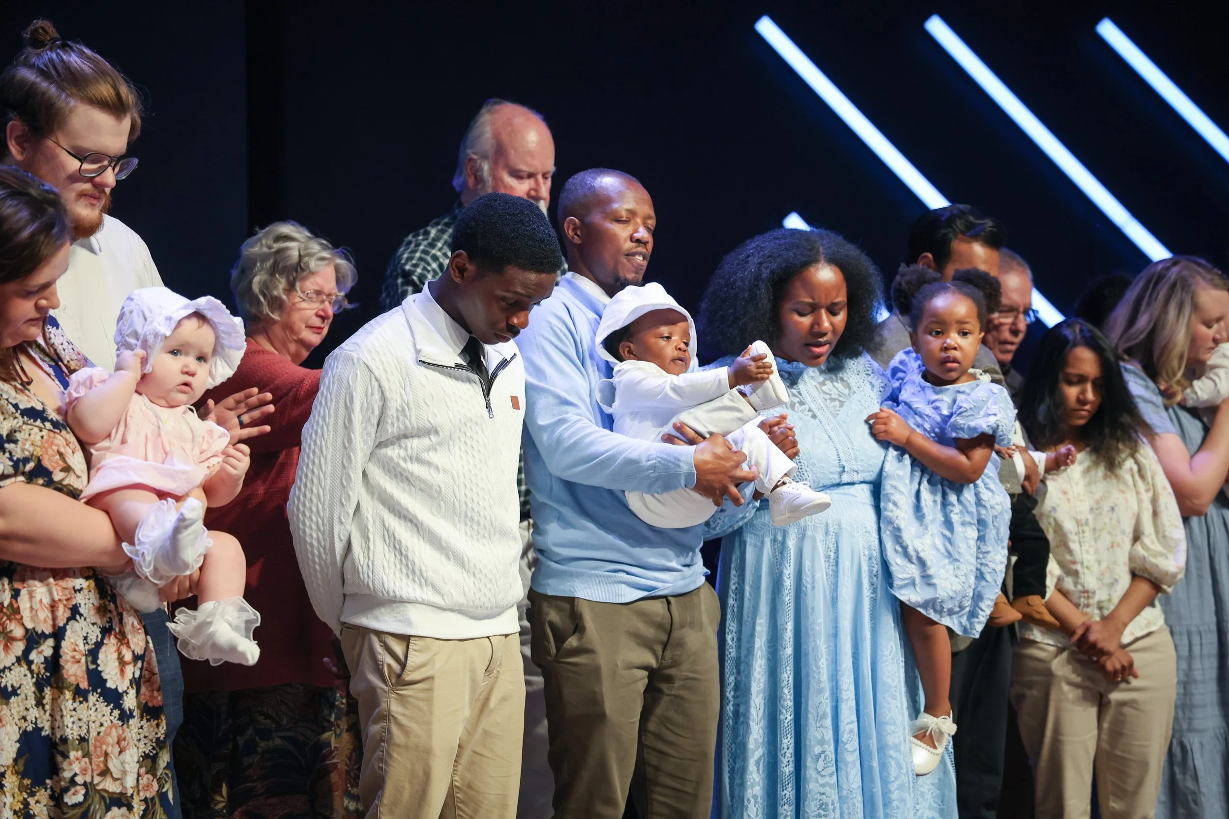 Families gathered on stage at Trinity Chapel