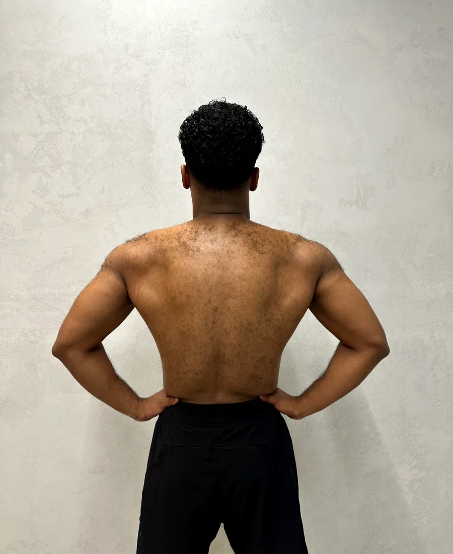 Rahman after 12-week transformation — wide back lat spread showing full muscle development at Fortius Dubai
