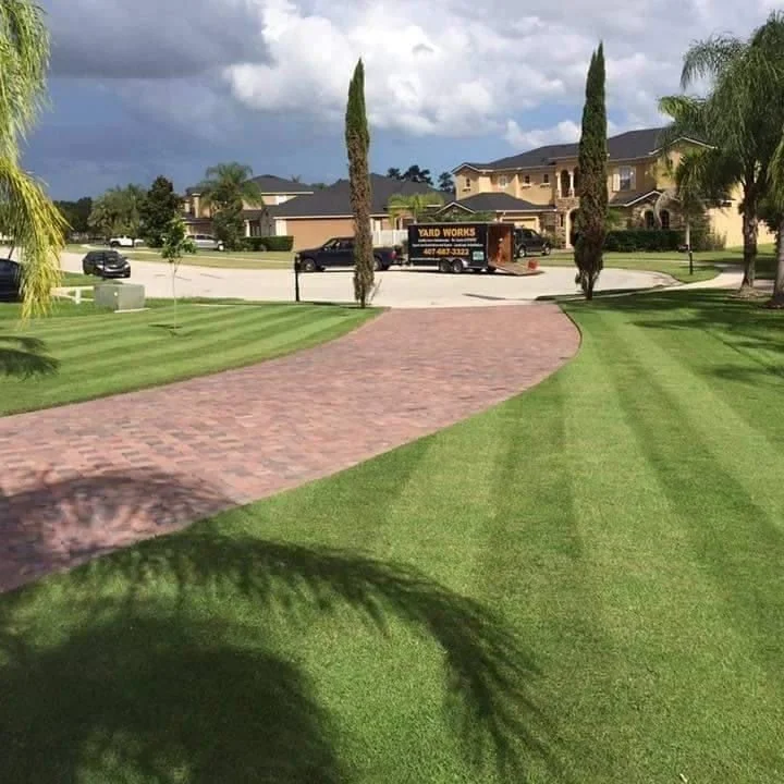 Winter Park St. Augustine lawn fronting paver driveway estate entrance