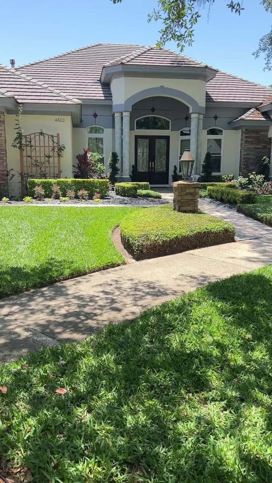 Oviedo estate front entry landscape installation with topiary by Yard Works
