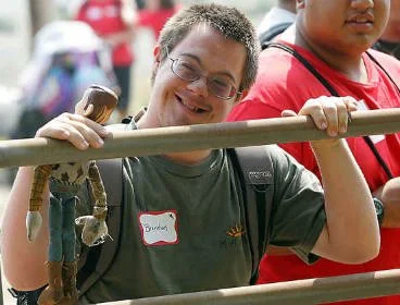 A smiling young man at a horseback riding outing with The Arc of Tri-Cities