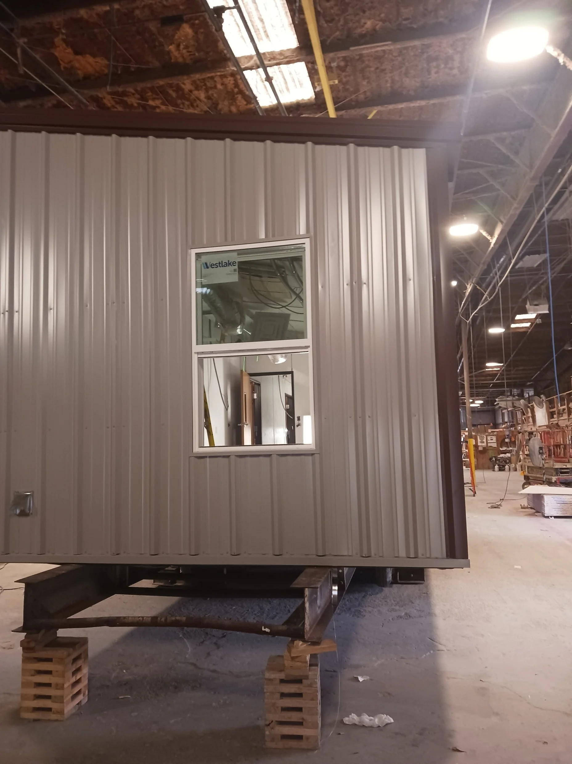 Exterior siding and a window on the intake center building during construction