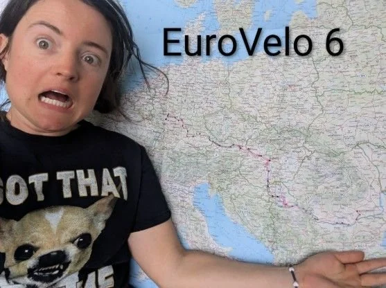 Skizzi making a mock-terrified face beside a map of Europe labeled EuroVelo 6, with the route traced across the continent