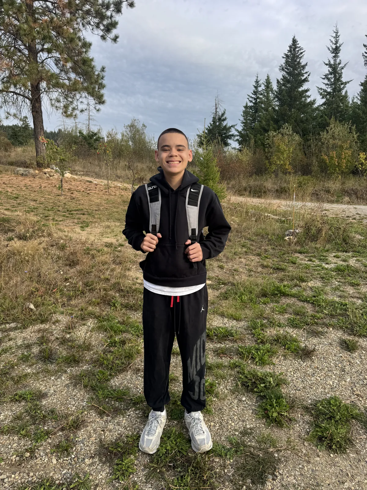 Liam Eby smiling outdoors with his backpack in September 2026