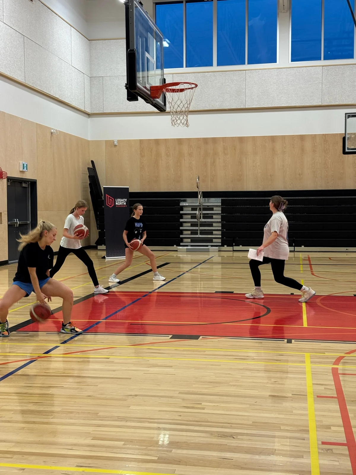 Girls practice basketball footwork during the 2025 She Is the Future program in Armstrong