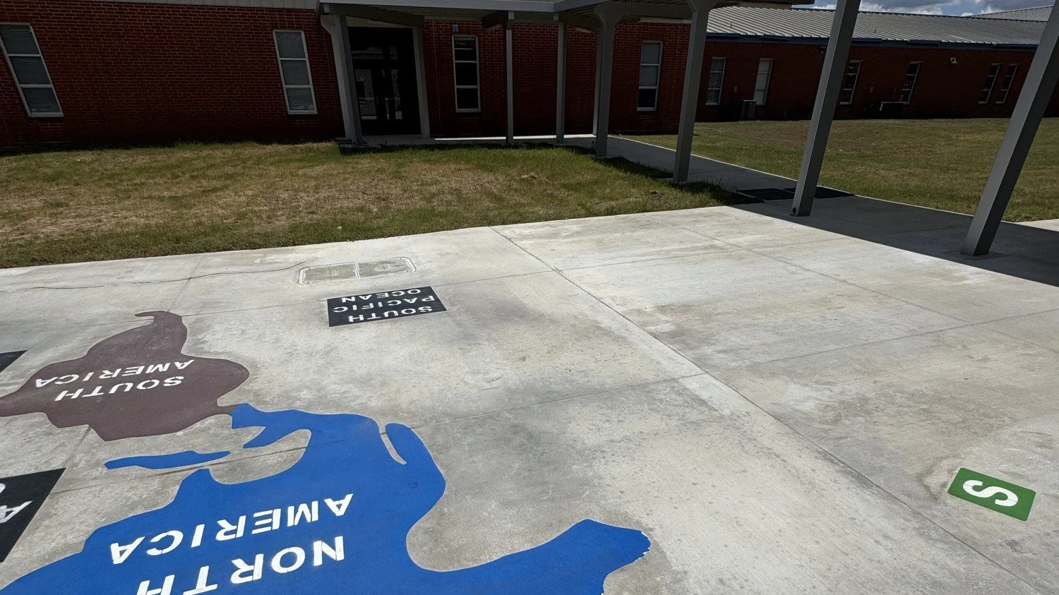 The same Blanco ISD white top playground after tire mark removal, surface clean and coating intact