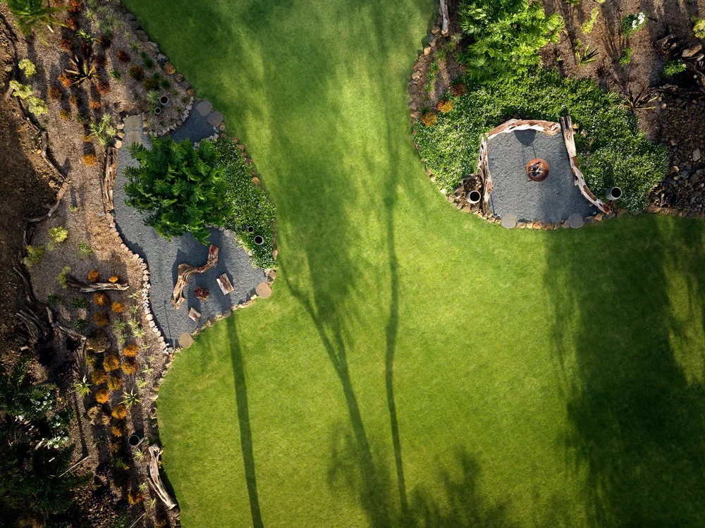 Overhead view of a lawn, gravel path and planting beds installed by Blooming Gardens
