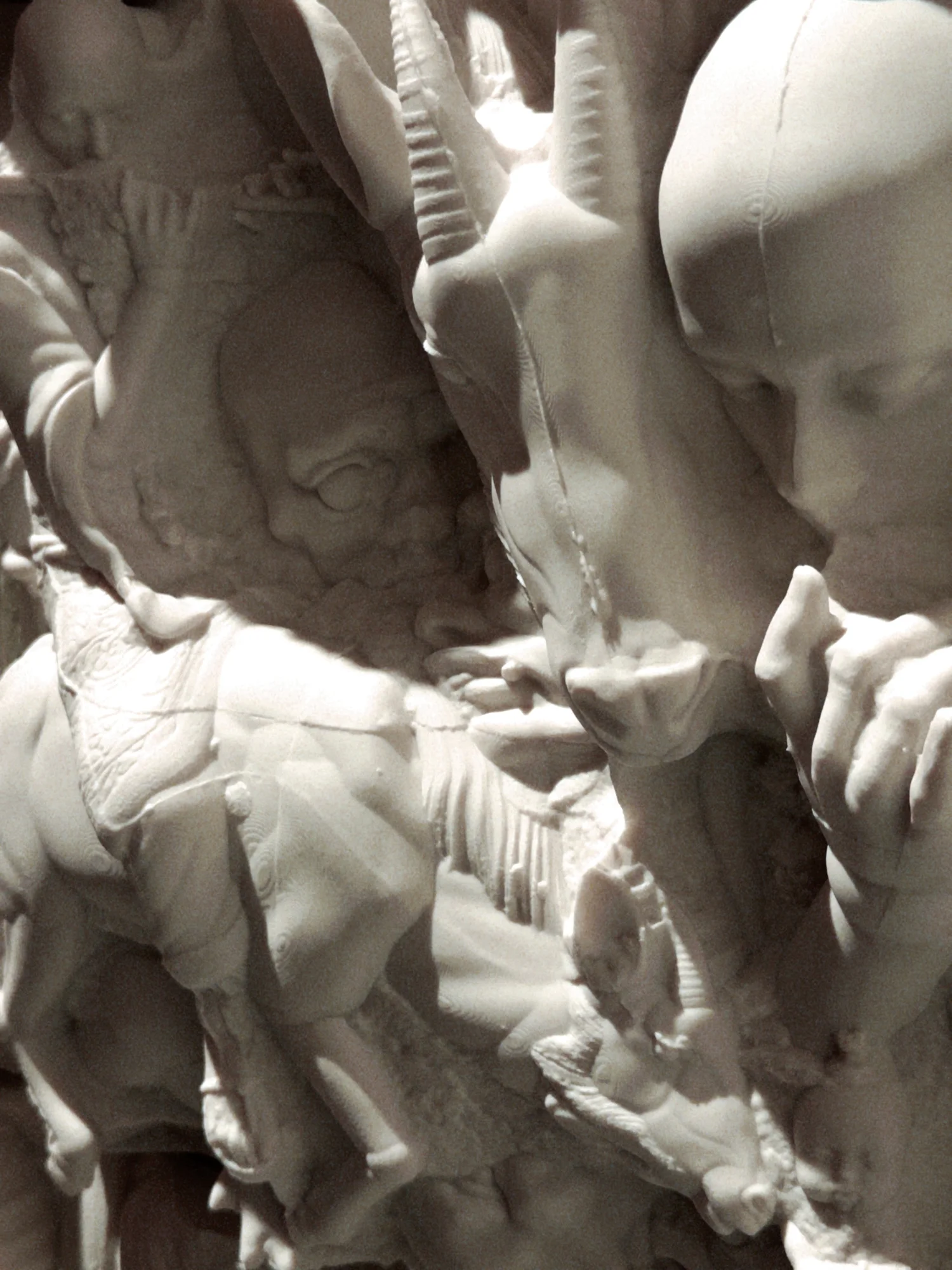 Close-up of clustered ceramic faces and fragments.