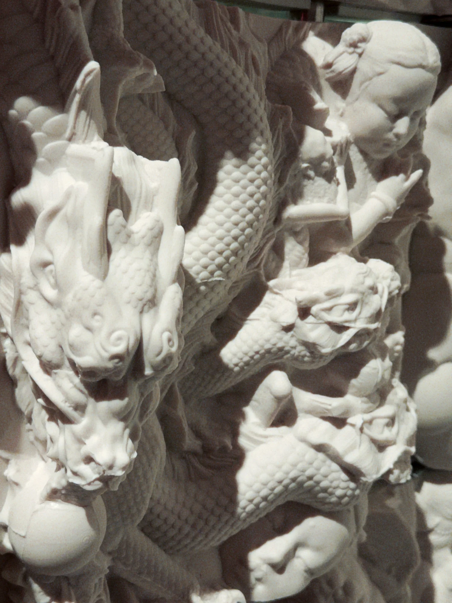 Close-up of ceramic animal forms, textured surfaces and human fragments.