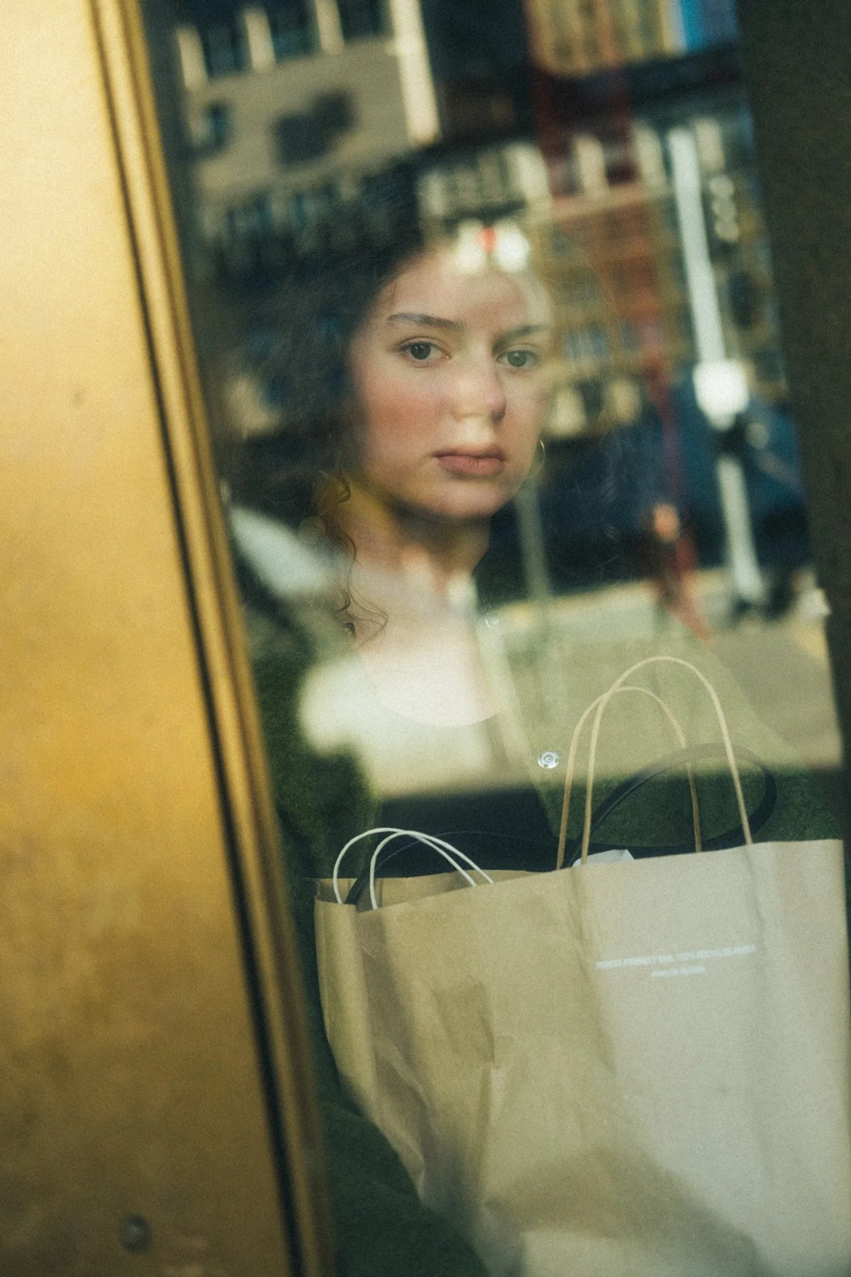 Olenka seen through a window layered with reflections