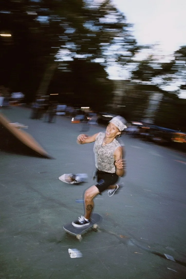 Color photograph of a smiling skater with visible motion blur