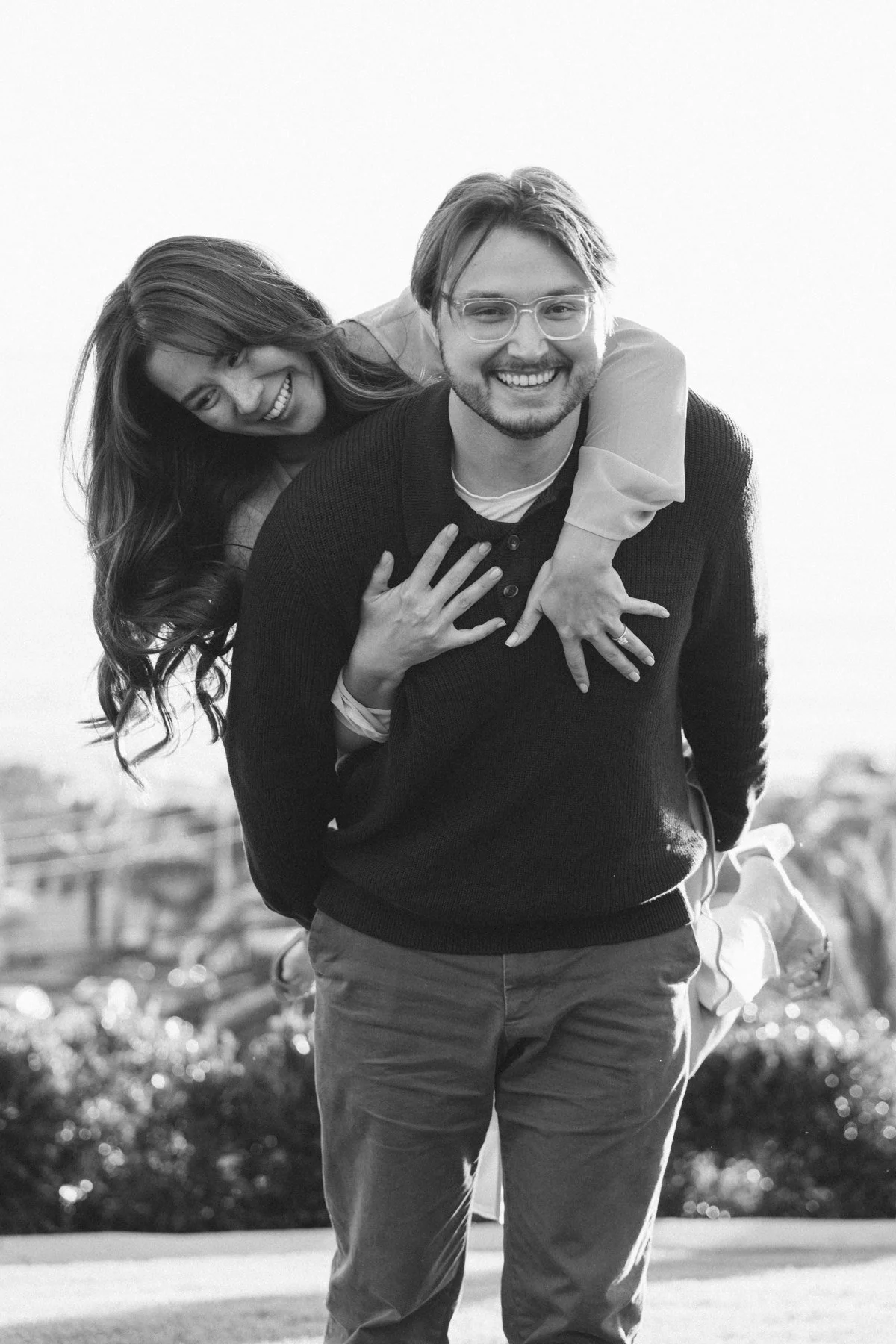 Black-and-white portrait of Hannah riding on Garrett’s back