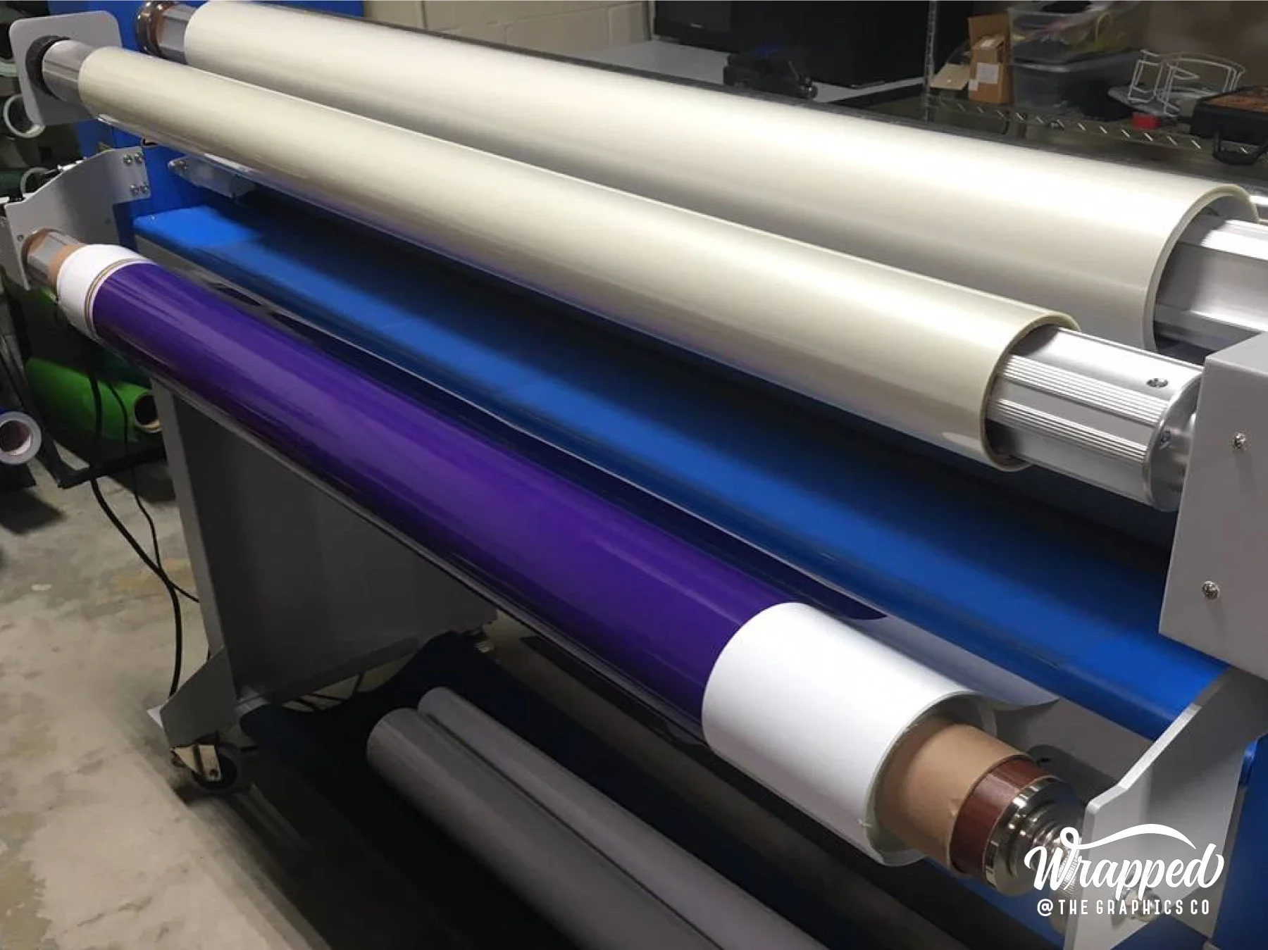 Blue and purple graphic material running through our laminator